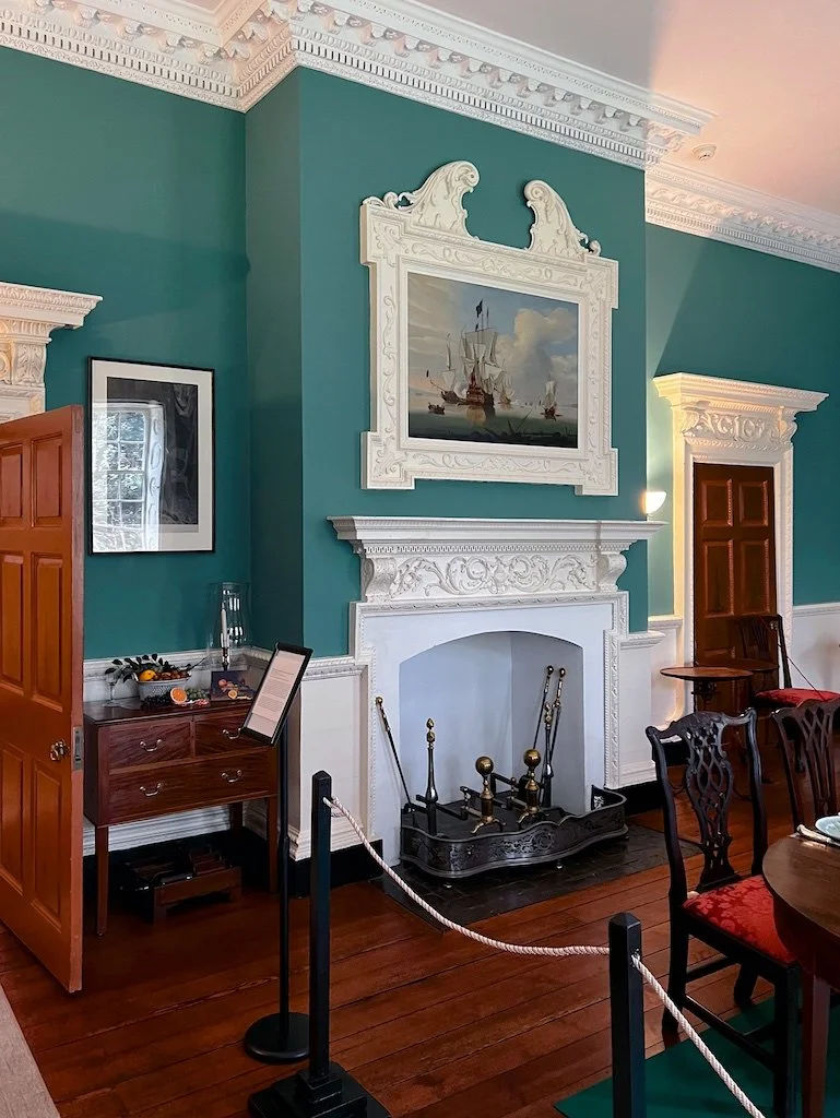 Dining Room: This room has the house's most elaborate wood and stucco decoration.  The faux door to the right continues the symmetrical design of the era.