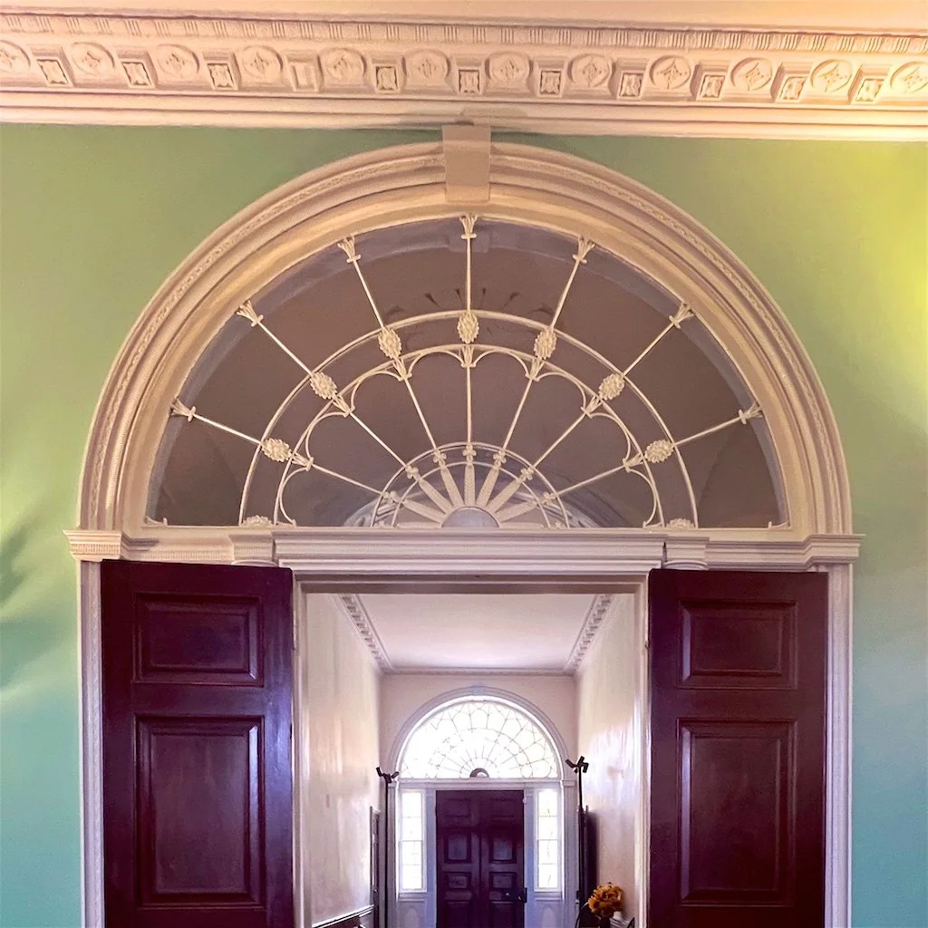 Homewood Central Hall: The placement of the fanlights along the axis of the cross hall takes advantage of natural light.