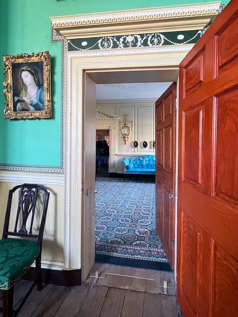 Front Parlor: Viewed from the New Room. This was the domain of Martha Washington for entertaining visitors and guests. The Wilton carpet was ordered in 1797 via Philadelphia. In 1785 the ceiling design was changed by John Rawlins to match what he did