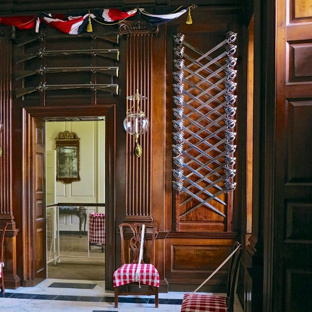 Entrance Hall: This room is recorded as completed in October of 1711. Then Governor Spotswood decorated it with a display of bayonet-tipped muskets. Colonial Williamsburg changed their original presentation of American walnut paneling to a white pain