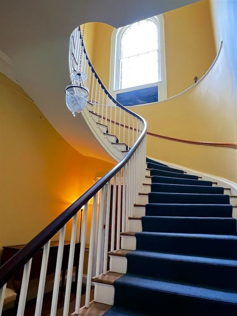 
Central Hall: The floor plan is formally arranged in a central hall plan with an elliptical curving staircase and four rooms, two on each side of the hall.