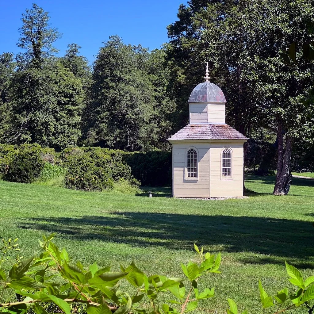 The Summer House is a rare existing hexagonal structure with a shingle roof, shiplap siding, and a cupola. The original structure was built in c. 1793.