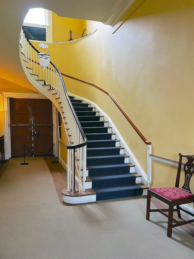 Central Hall:  An elliptical curving staircase is the focal point of the Central Hall and a trademark of architect William Thornton.