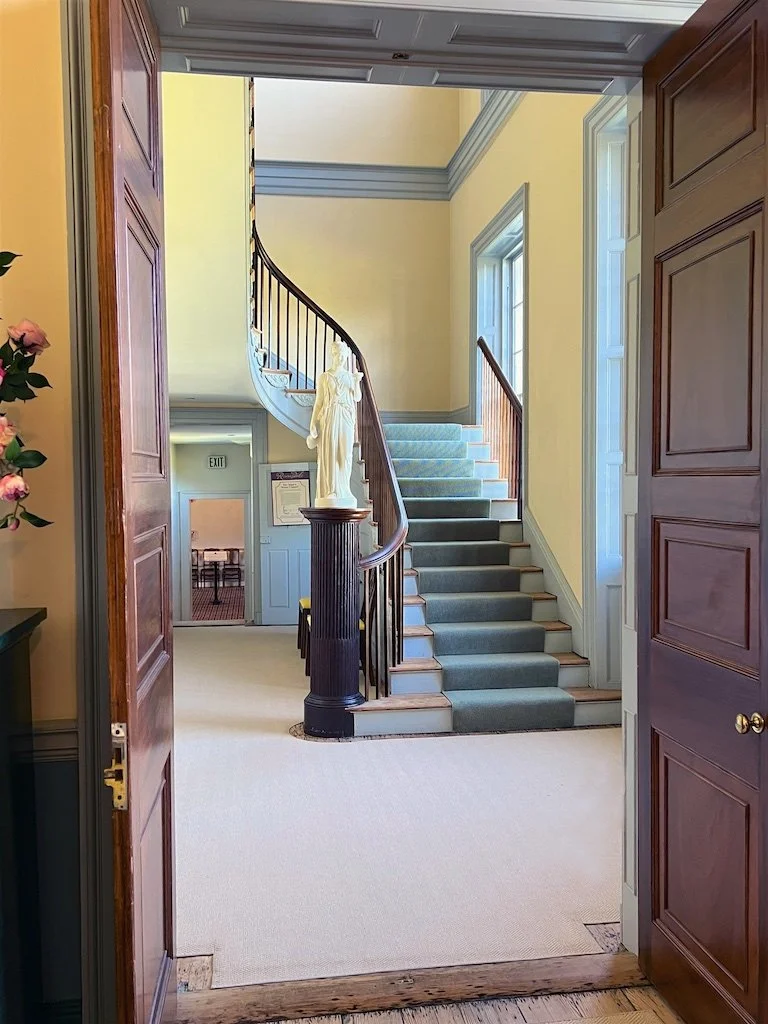 On the north side is a central entry hall, with a stair hall on the right and a service hall on the left. All spaces have elaborate original woodwork.