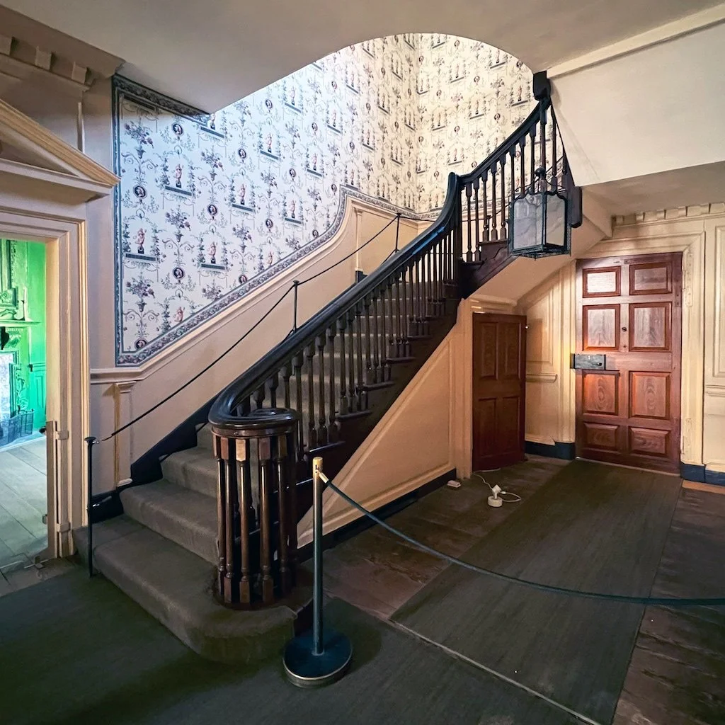 Central Passage: The Central Passage runs the width of the house. The black-walnut staircase was added in the 1758-1759 expansion of Mount Vernon - Washington added the french wallpaper in the 1790s along with painting to match the Front Parlor.