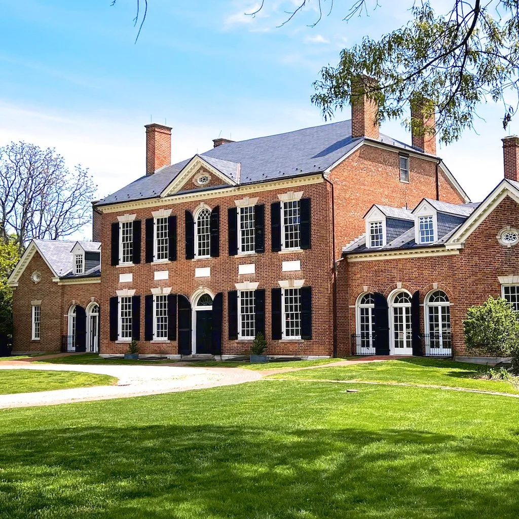 Woodlawn West (Carriage) Facade: Built c. 1800-1805, Woodlawn is a 5-part  brick house in Georgian/Federal style. The influence coming from Robert Adam is growing in America. His British dominance in architecture and interiors crossed the Atlantic to