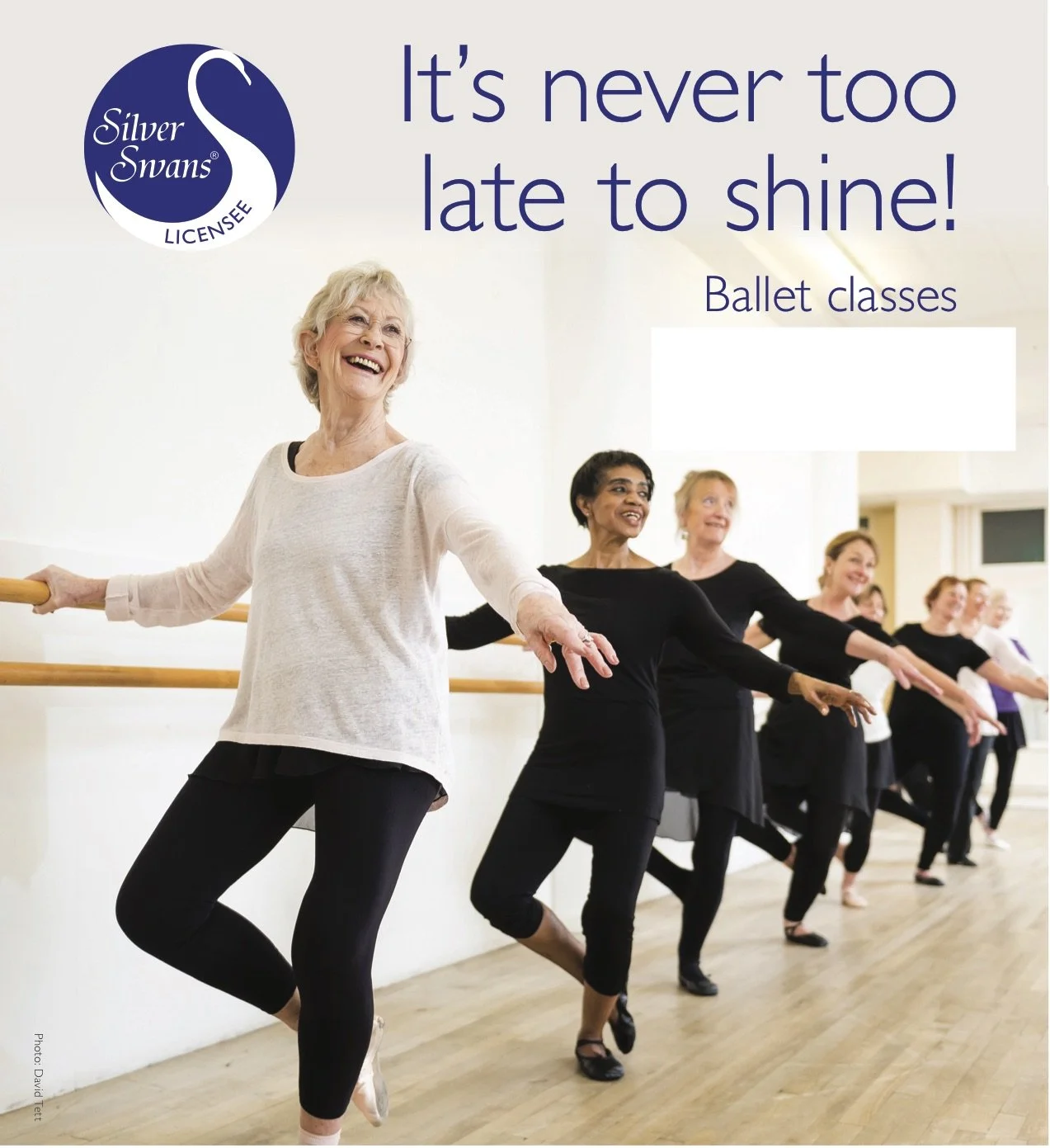 A group of senior women participating in ballet classes at a dance studio, practicing at the barre and smiling.