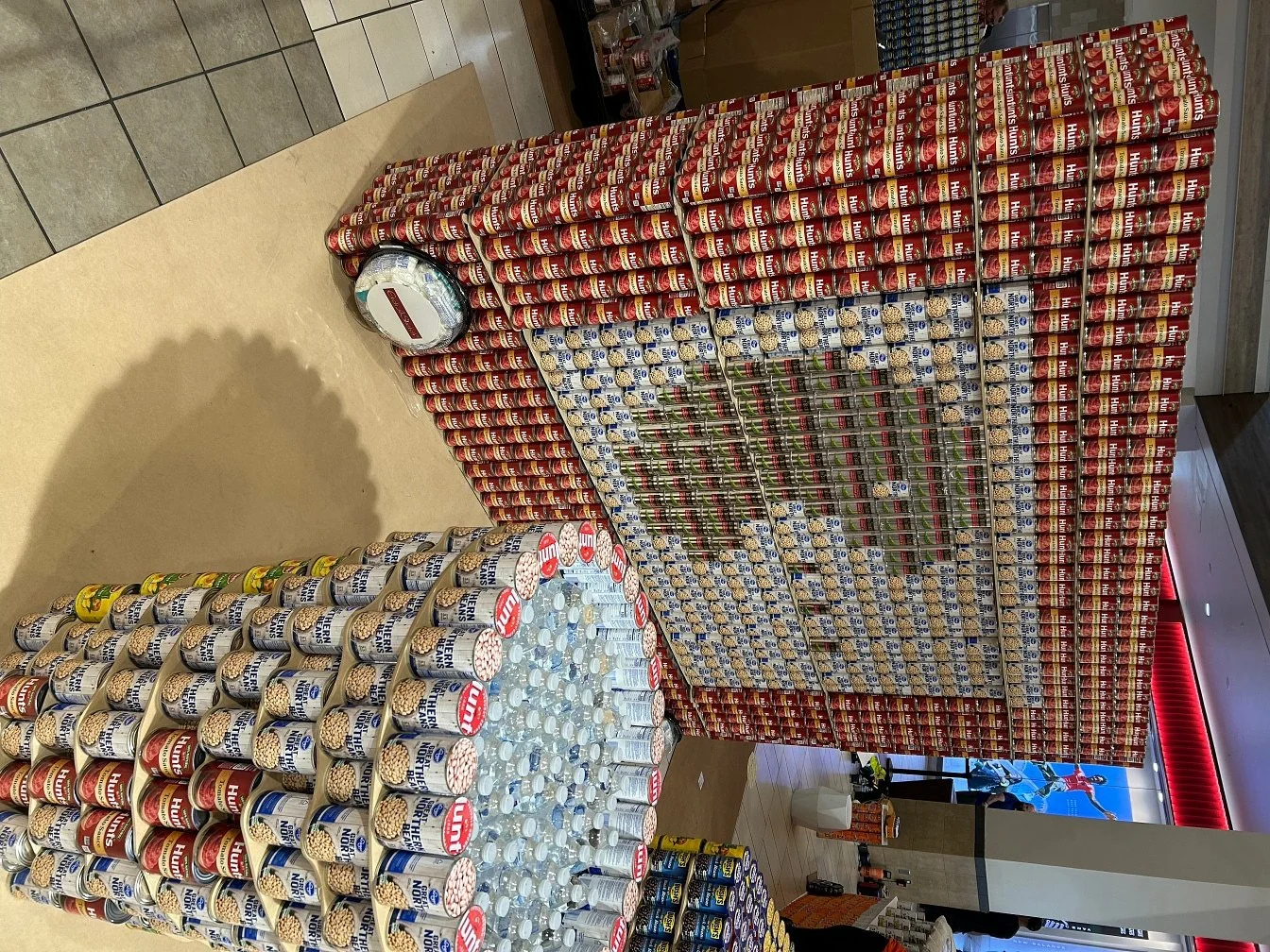Cans stacked to create a sculpture of a pacman game