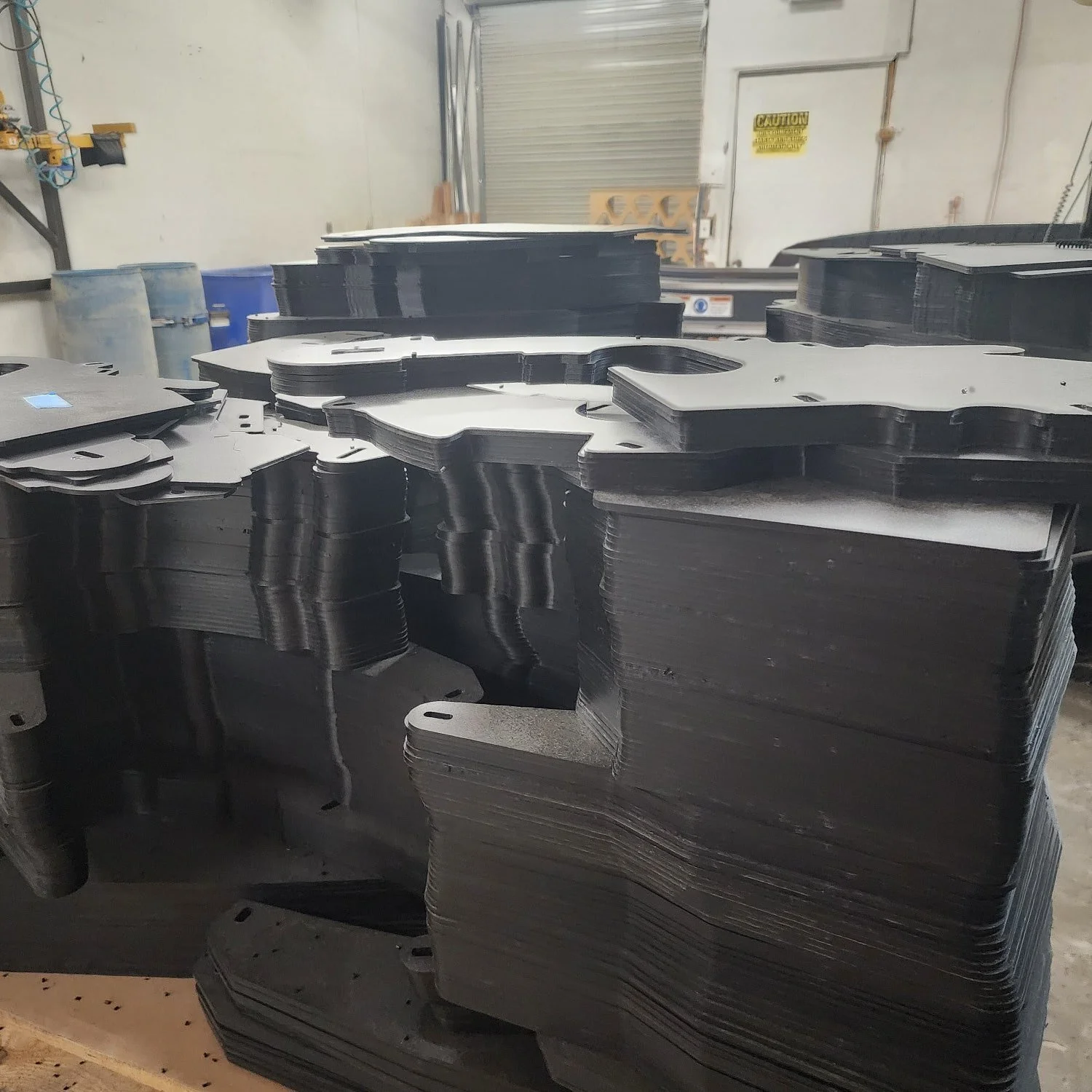 Stacks of black ABS plastic production parts