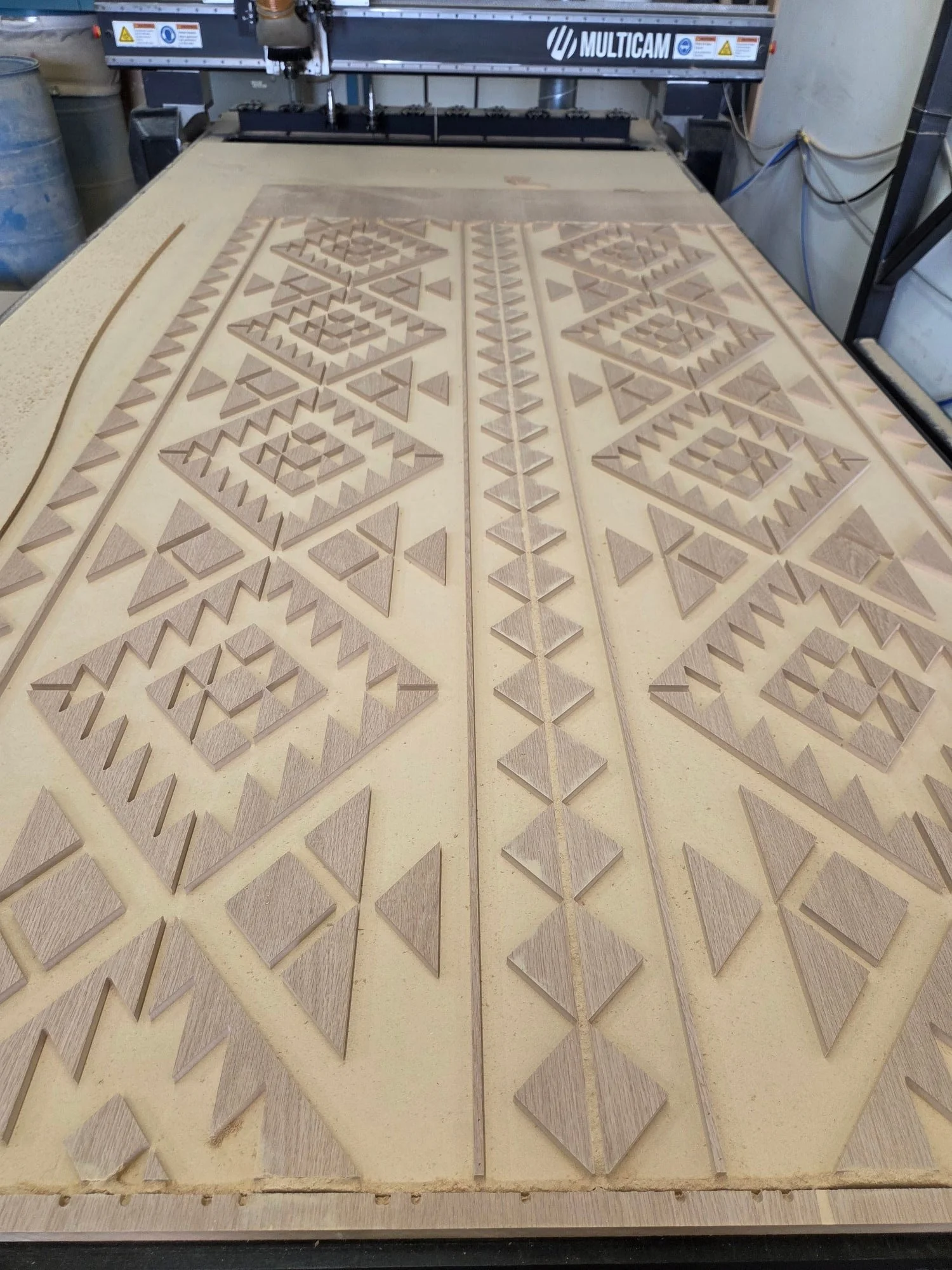 A geometric pattern that's been carved into a sheet of MDF