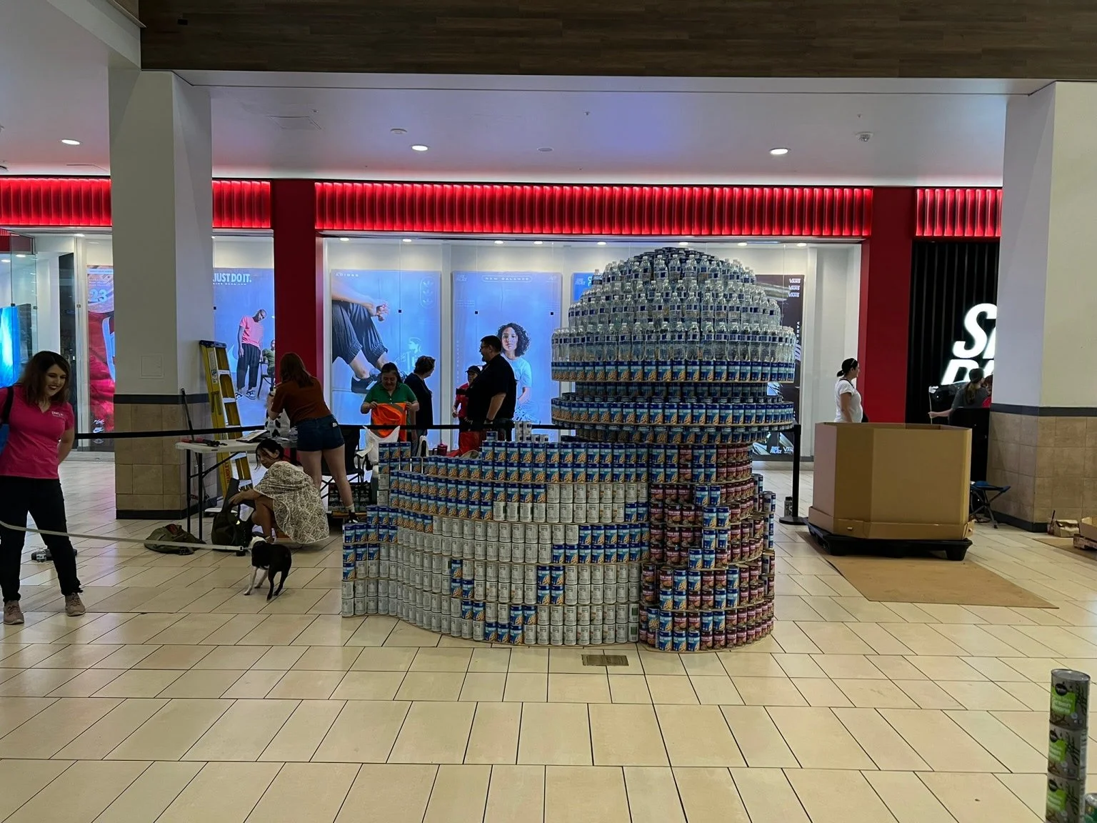 Cans stacked to create an art display of a large kiosk