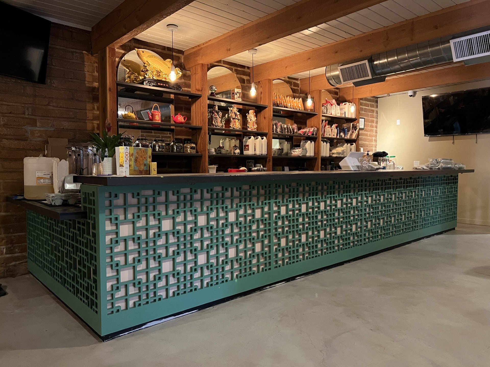 Green, decorative wood paneling around a cabinet space.