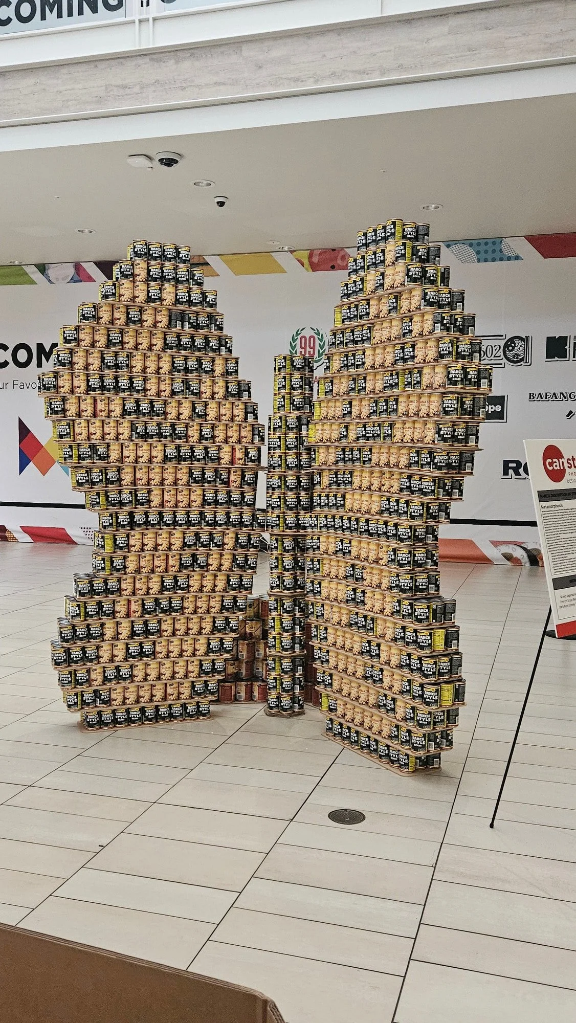 Cans stacked to create an art display of a large butterfly