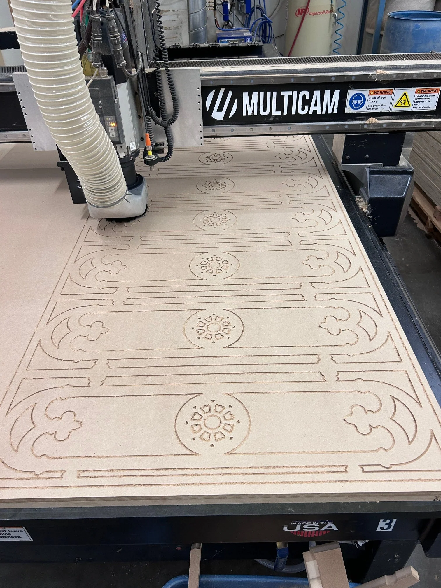 An intricate design etched into a sheet of MDF