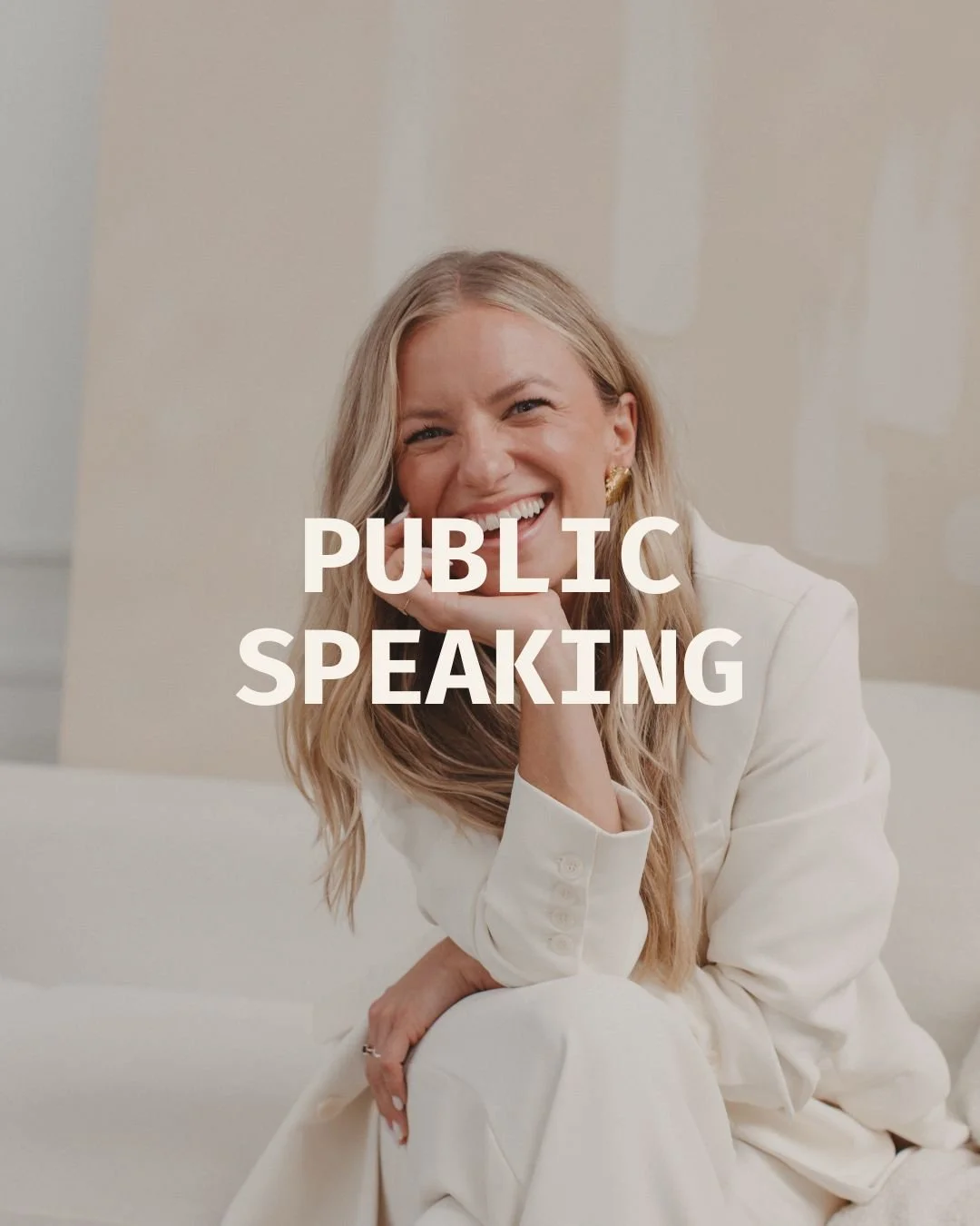 A woman smiling and sitting on a white couch, dressed in a white outfit, with the text 'Public Speaking' overlayed on the image.