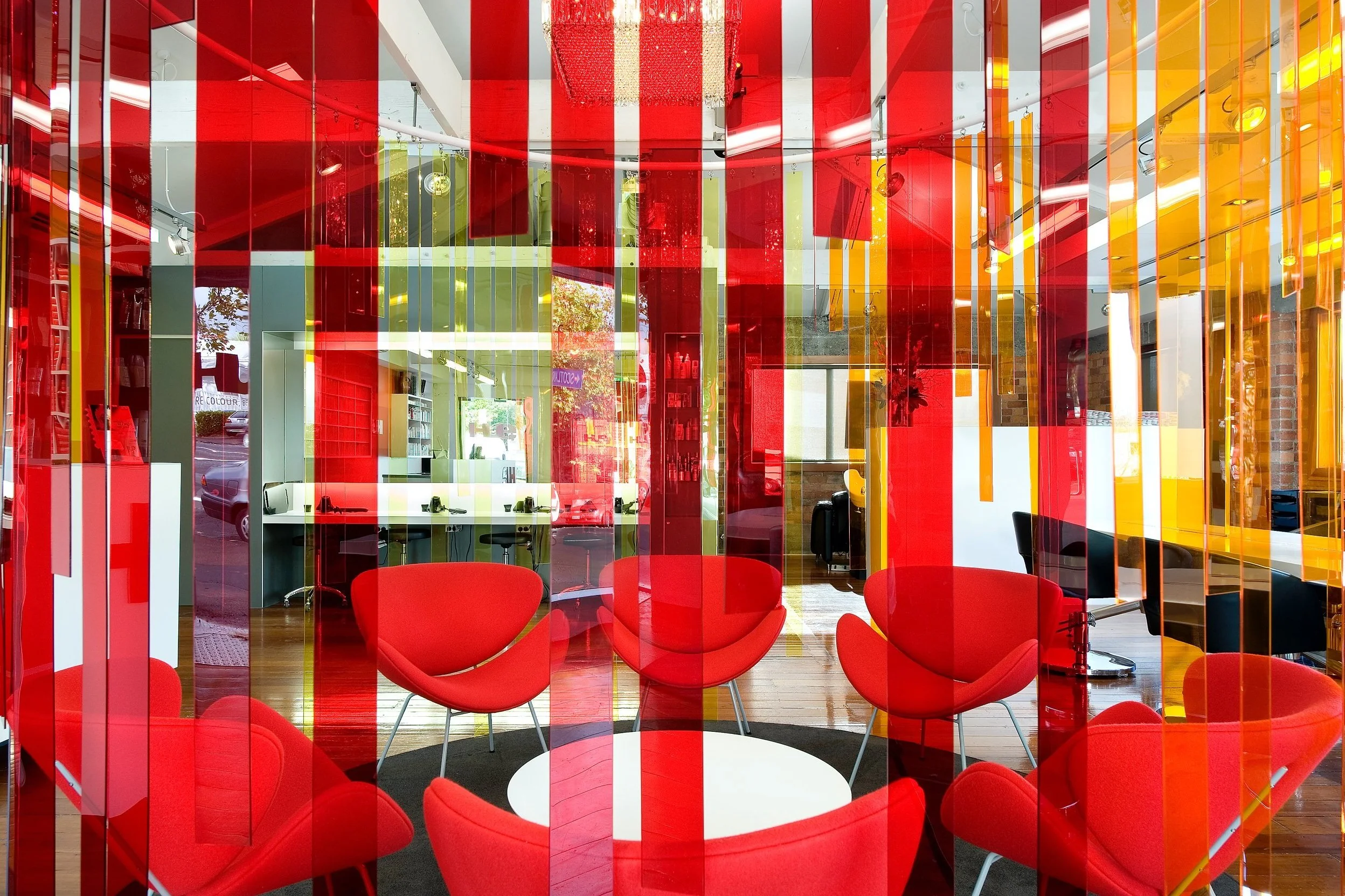 Looking through the strip screen to the waiting chairs and the cutting stations