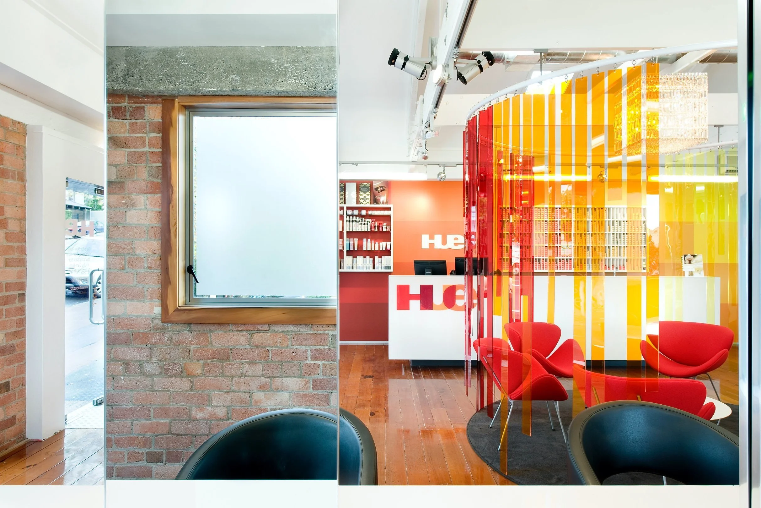 The brick wall and window kept from the old building, beside the strip screen