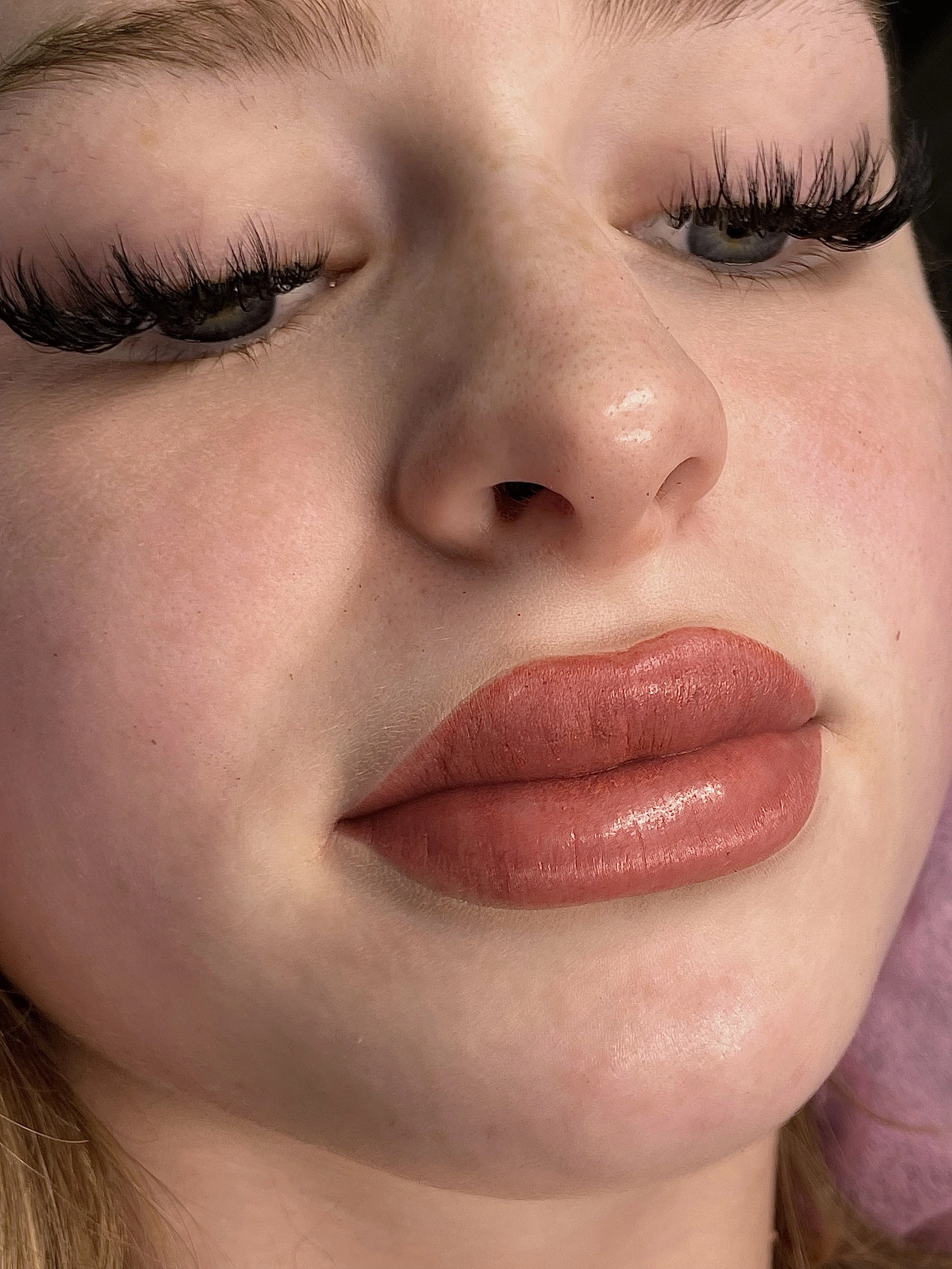 Expert applying custom lip blush services in Yuma, AZ for subtle, long-lasting color and a youthful smile.