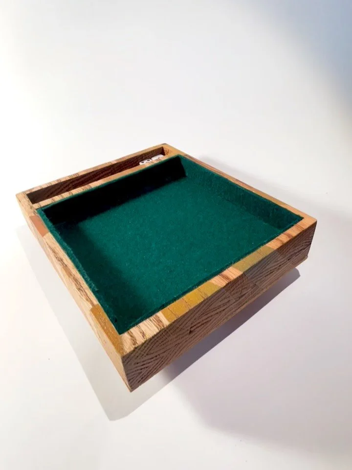 A dice tray! 

This was a fun project to bring to life with a lot of different materials and styles that I had never put into one project. So psyched with the final result. 

The piece is an oak tray with painted sides, a cork bottom, and lined with 