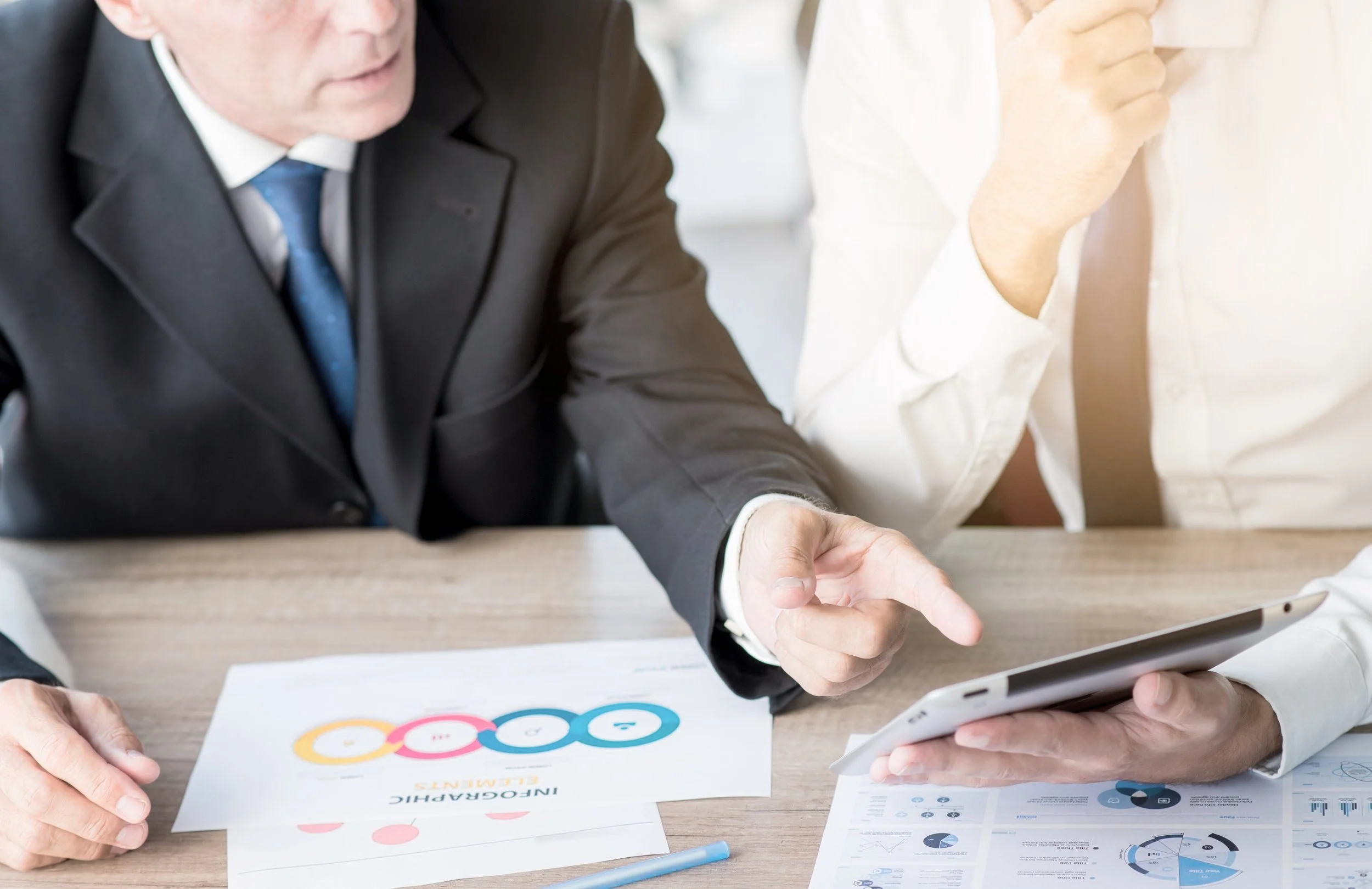 businessman-pointing-finger-digital-tablet-hold-by-his-partner-workplace.jpg