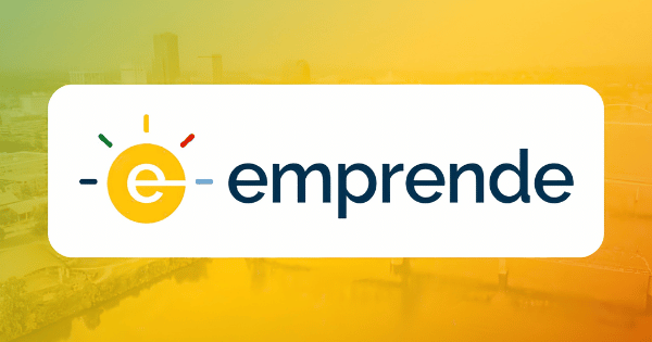 Logo with a yellow lightbulb containing a lowercase 'e', and the word 'emprende' on a yellow and green cityscape background.