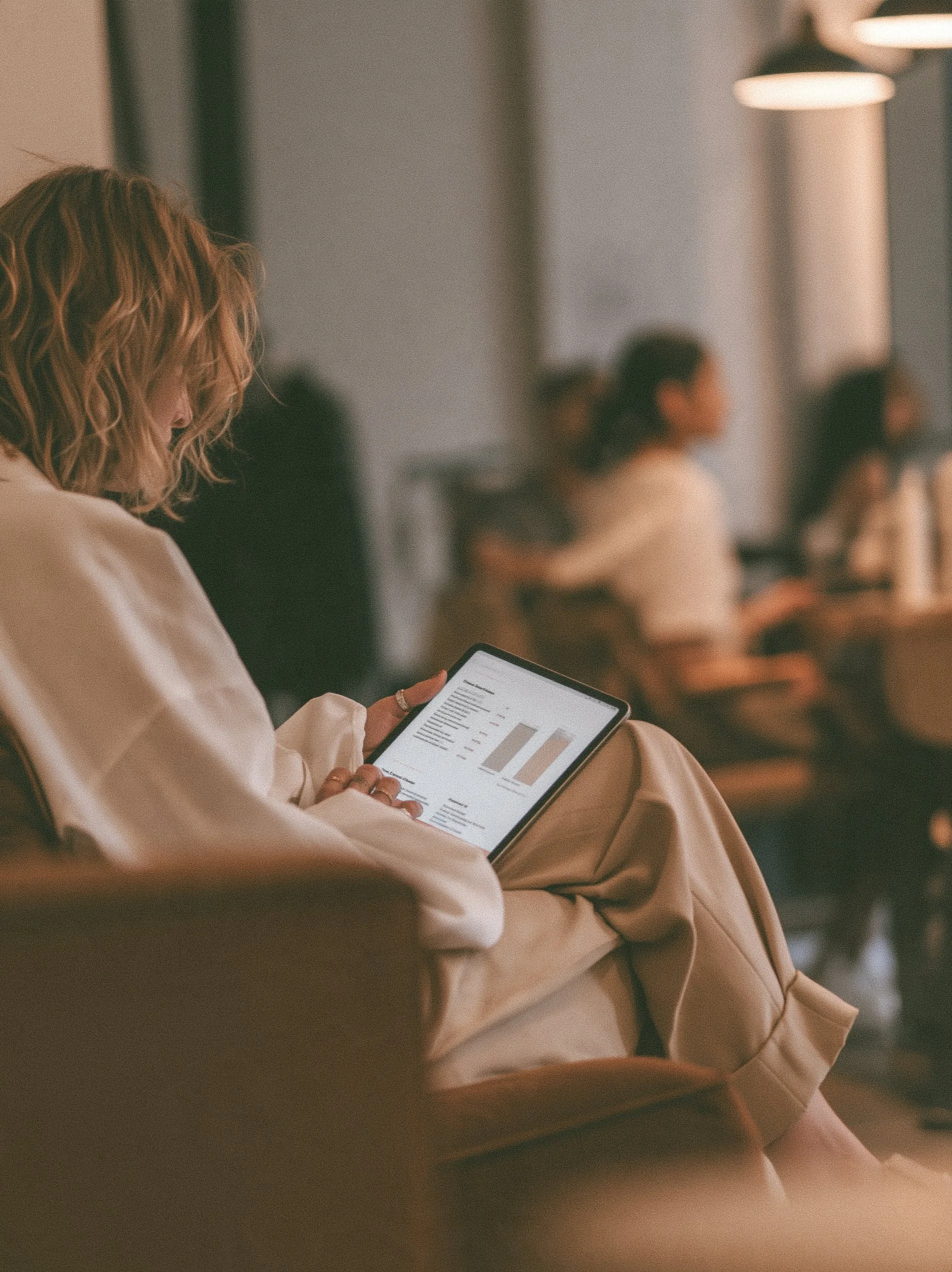 Big Little Content: a stylist reviewing business figures on a tablet in a modern salon