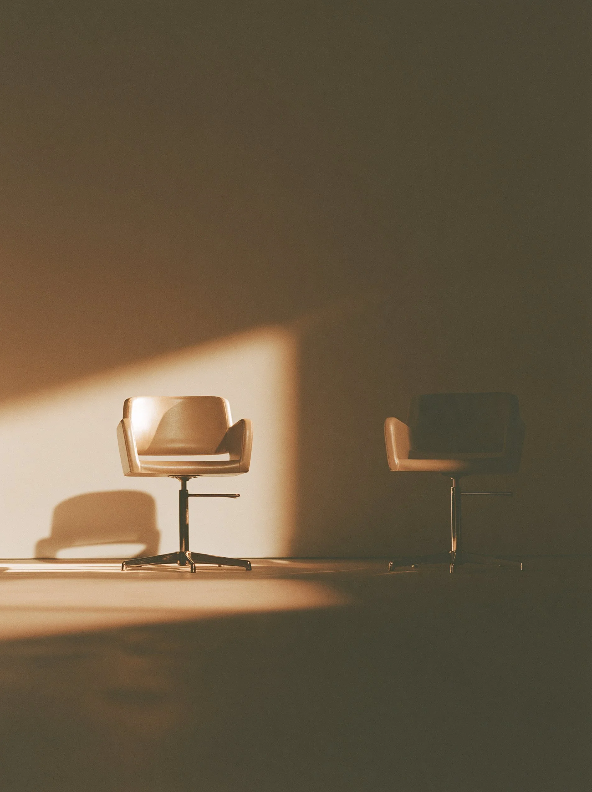 Big Little Content: two identical salon chairs side by side, one lit and one in shadow