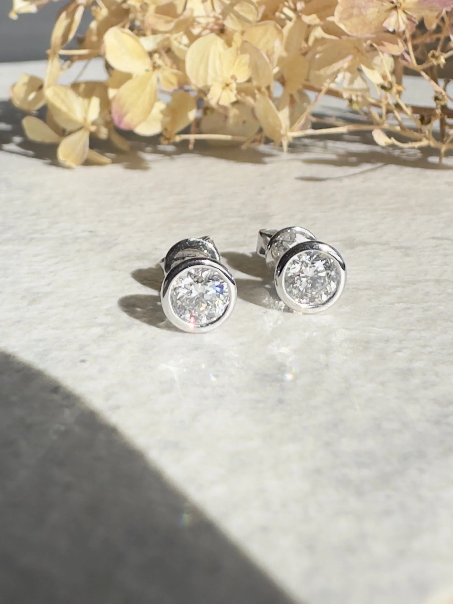 rub-over diamond stud earrings in platinum