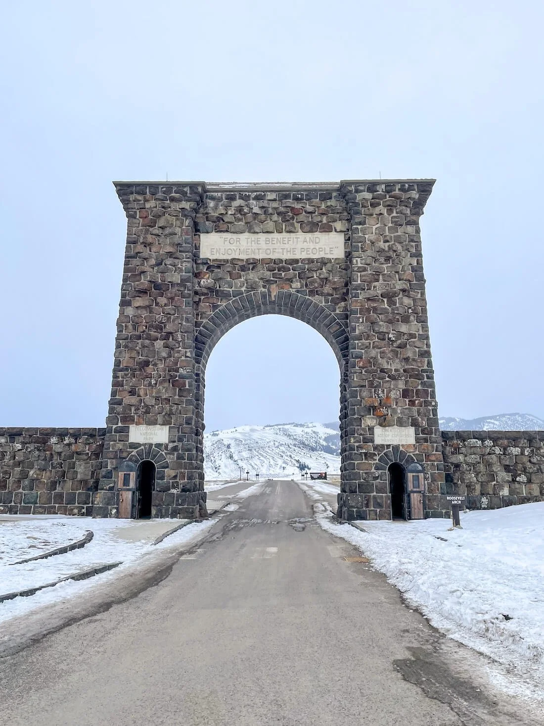 large stone arch over roadway into Yellowstone National Park