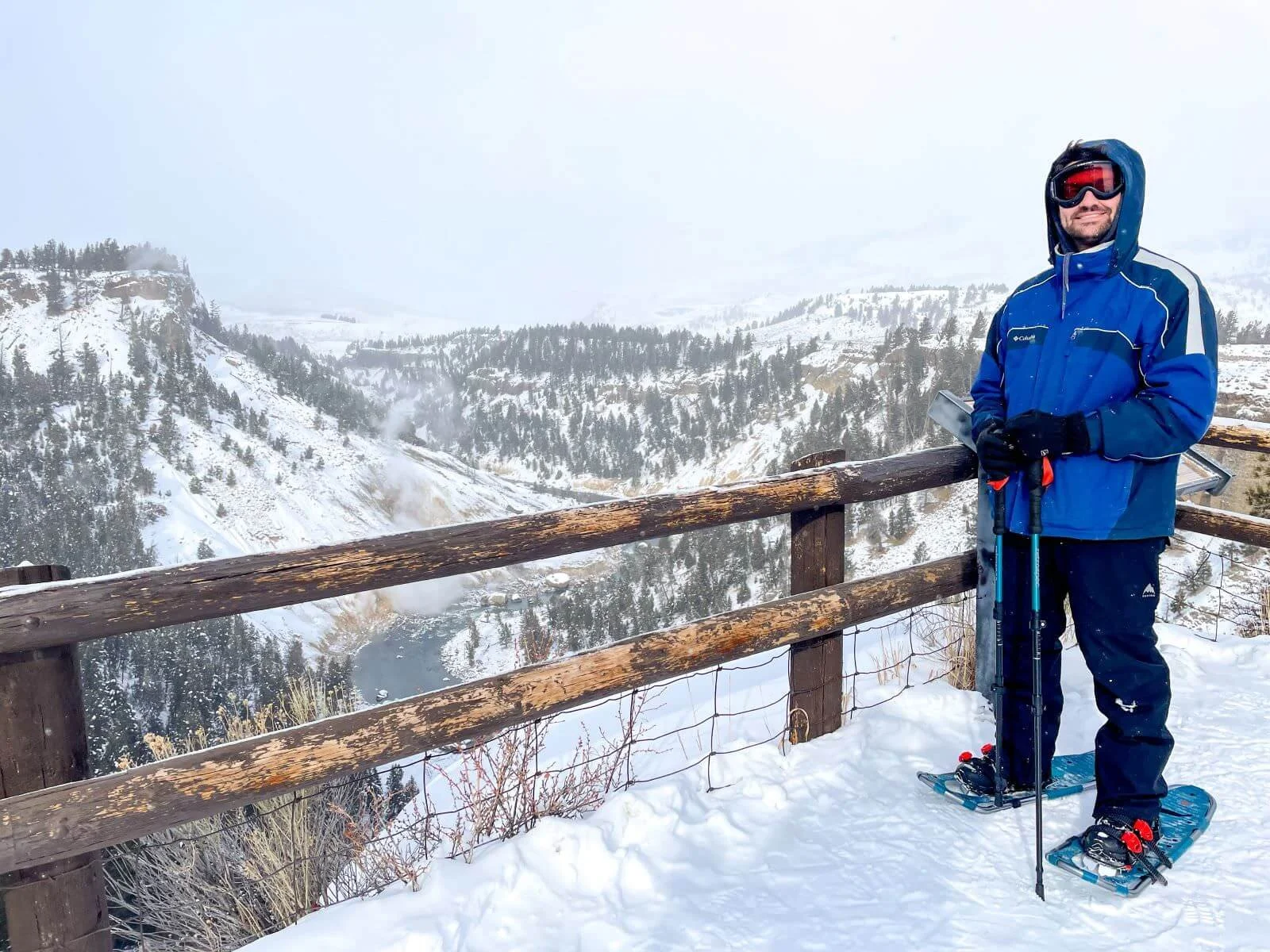 man in snowshoes in front of steaming river area