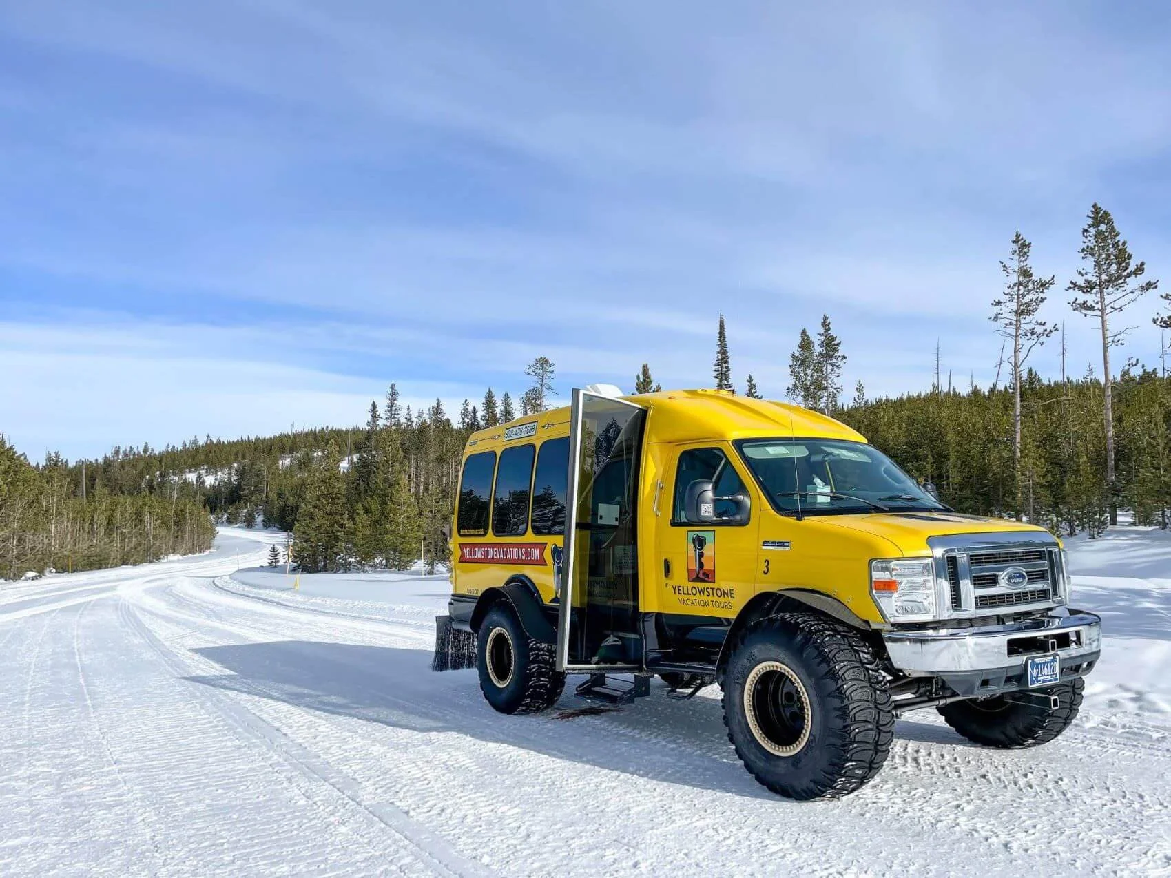 yellow bus on groomed snow trail