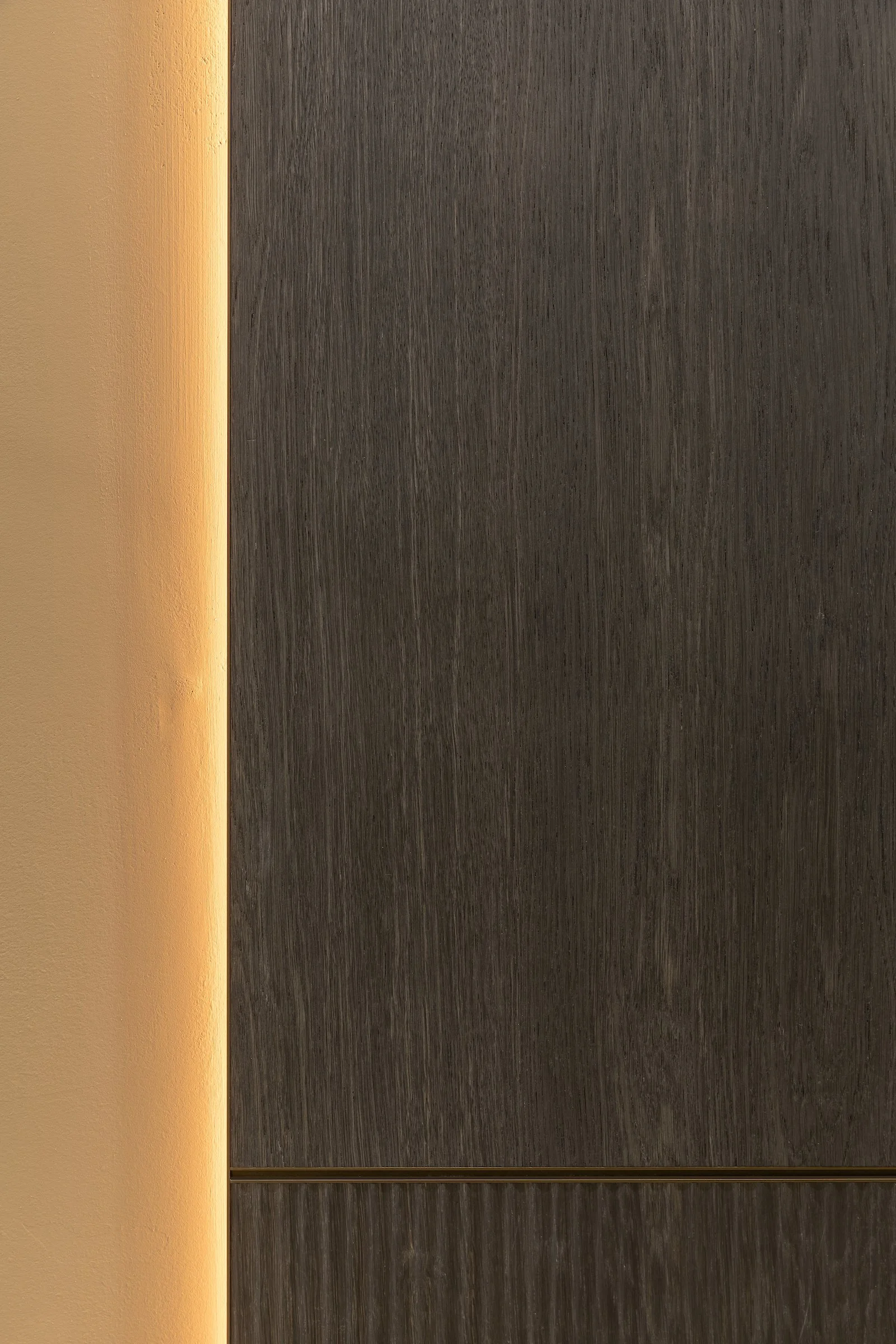 Luxury wall panelling in a dark oak finish with hidden lights - new project in London.