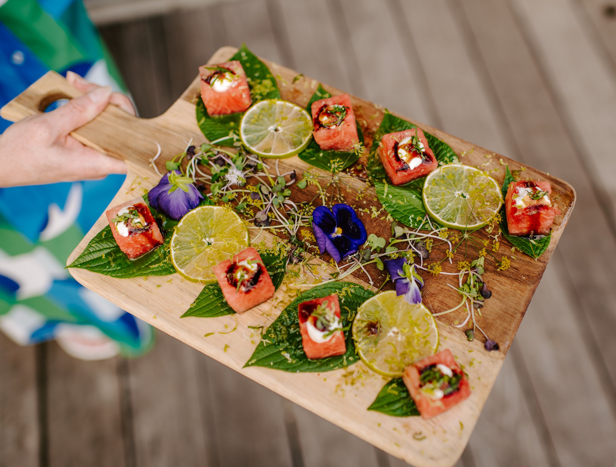 Fresh summer watermelon bites with lime zest, herbs, and edible flowers — perfect for weddings and upscale catered events in Milwaukee and Southeastern Wisconsin