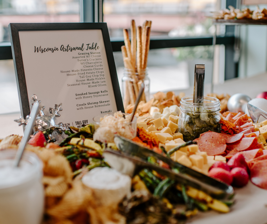 Holiday buffet with local cheeses, meats, and seasonal decor