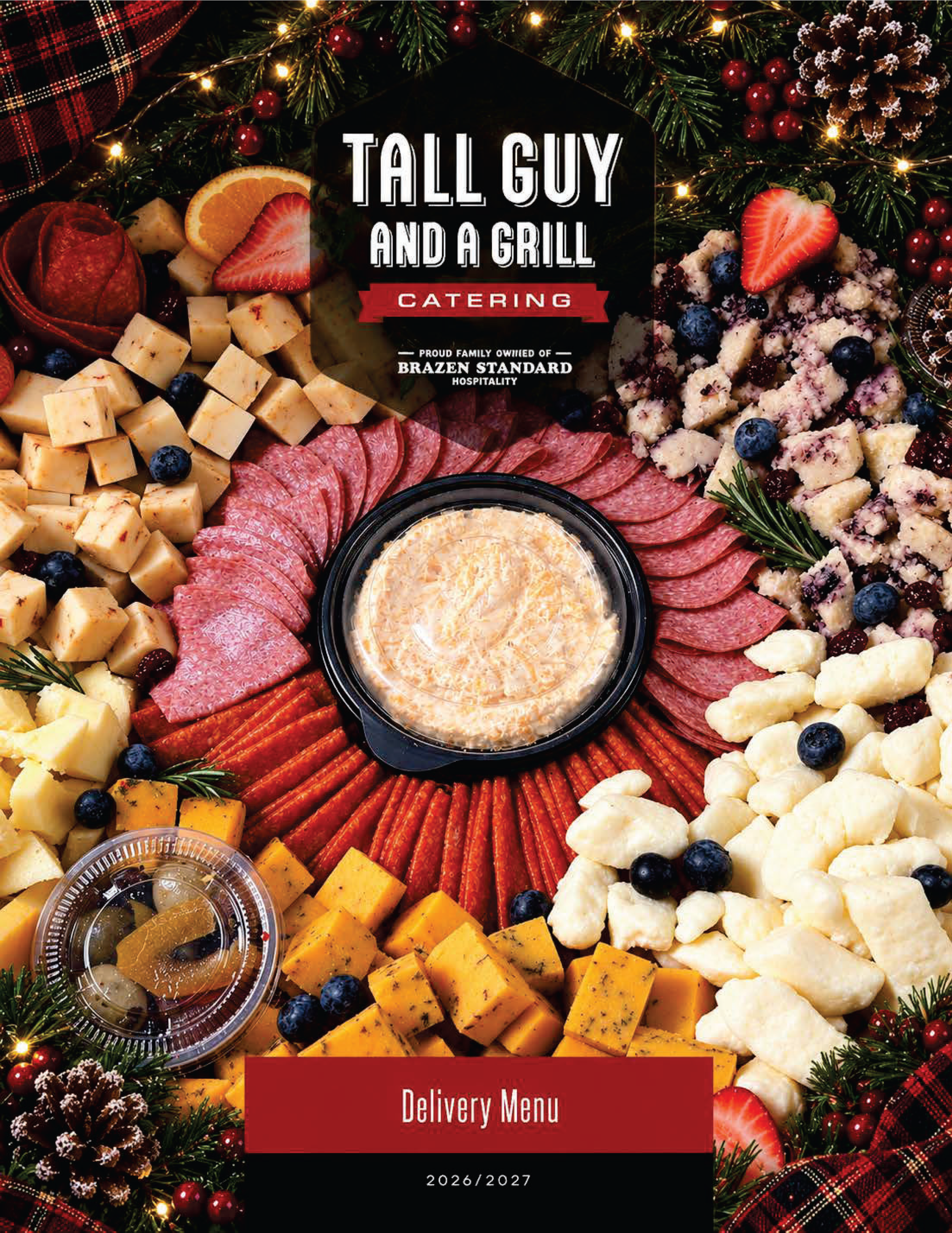Holiday Menu with hummus, meats, cheeses, and holiday decor and tinsel.