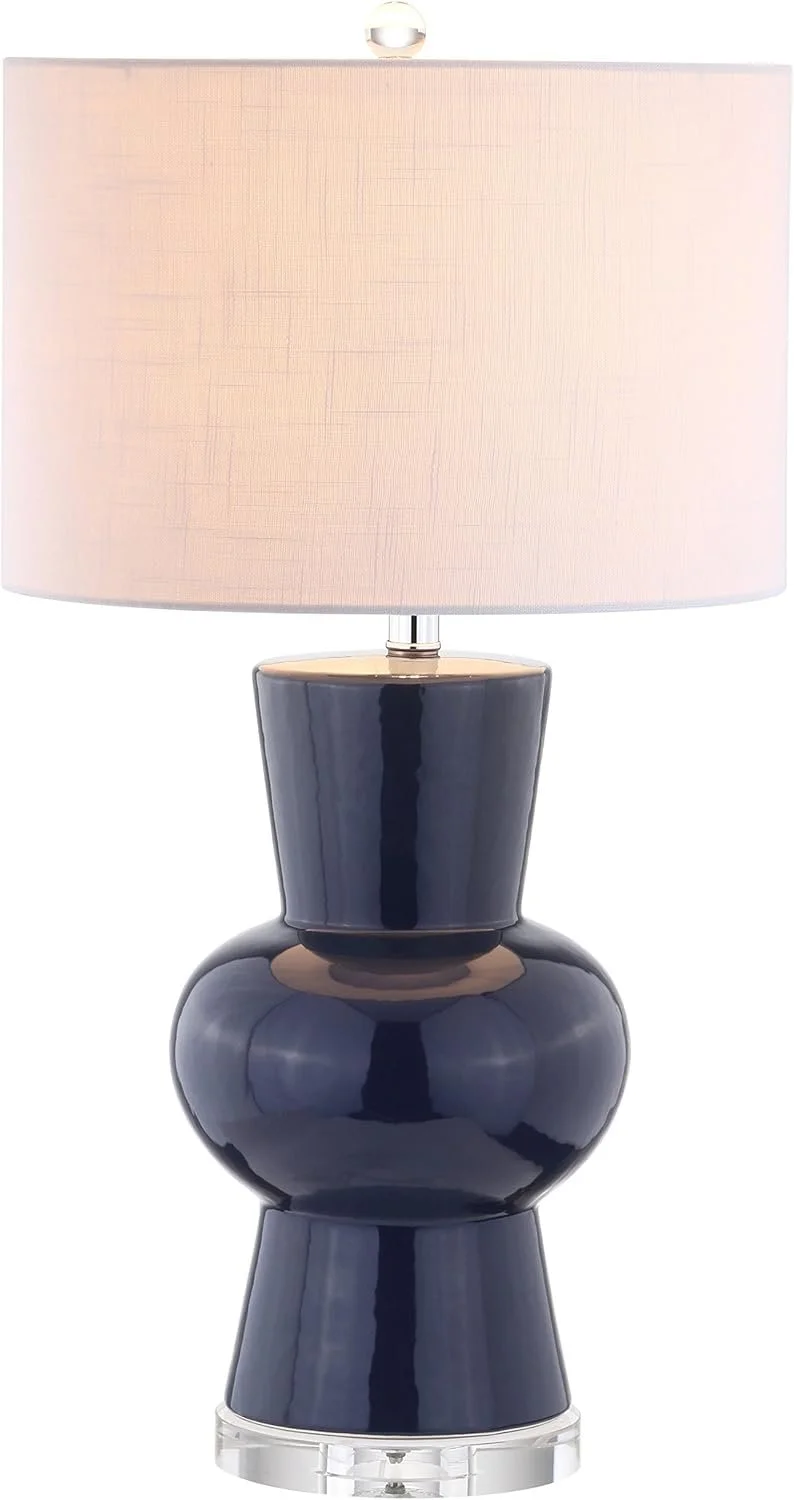 Navy ceramic table lamp with a curved base and cream linen drum shade