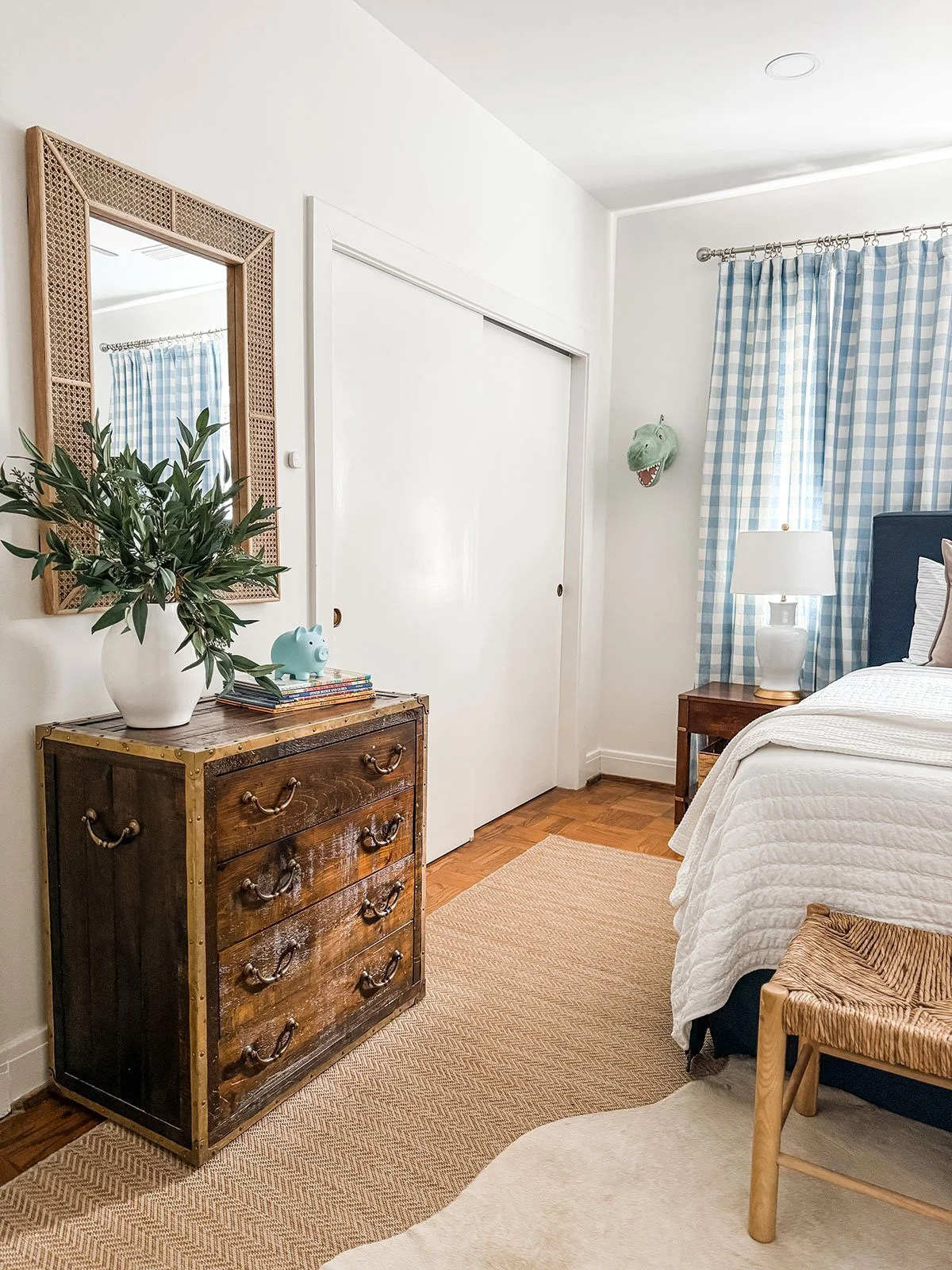 neutral rustic little boys room with vintage dresser and blue gingham curtains