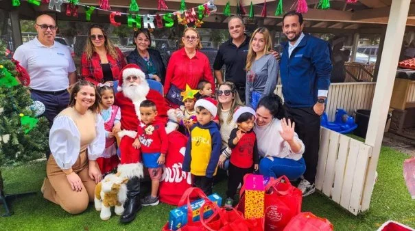 Children and associates at a Bomnin holiday toy giveaway