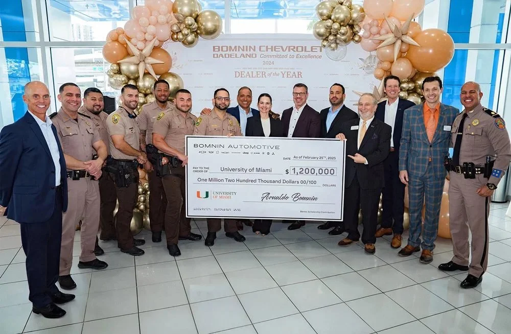 The Bomnin family, University of Miami leaders, and first responders presenting the $1.2 million scholarship check