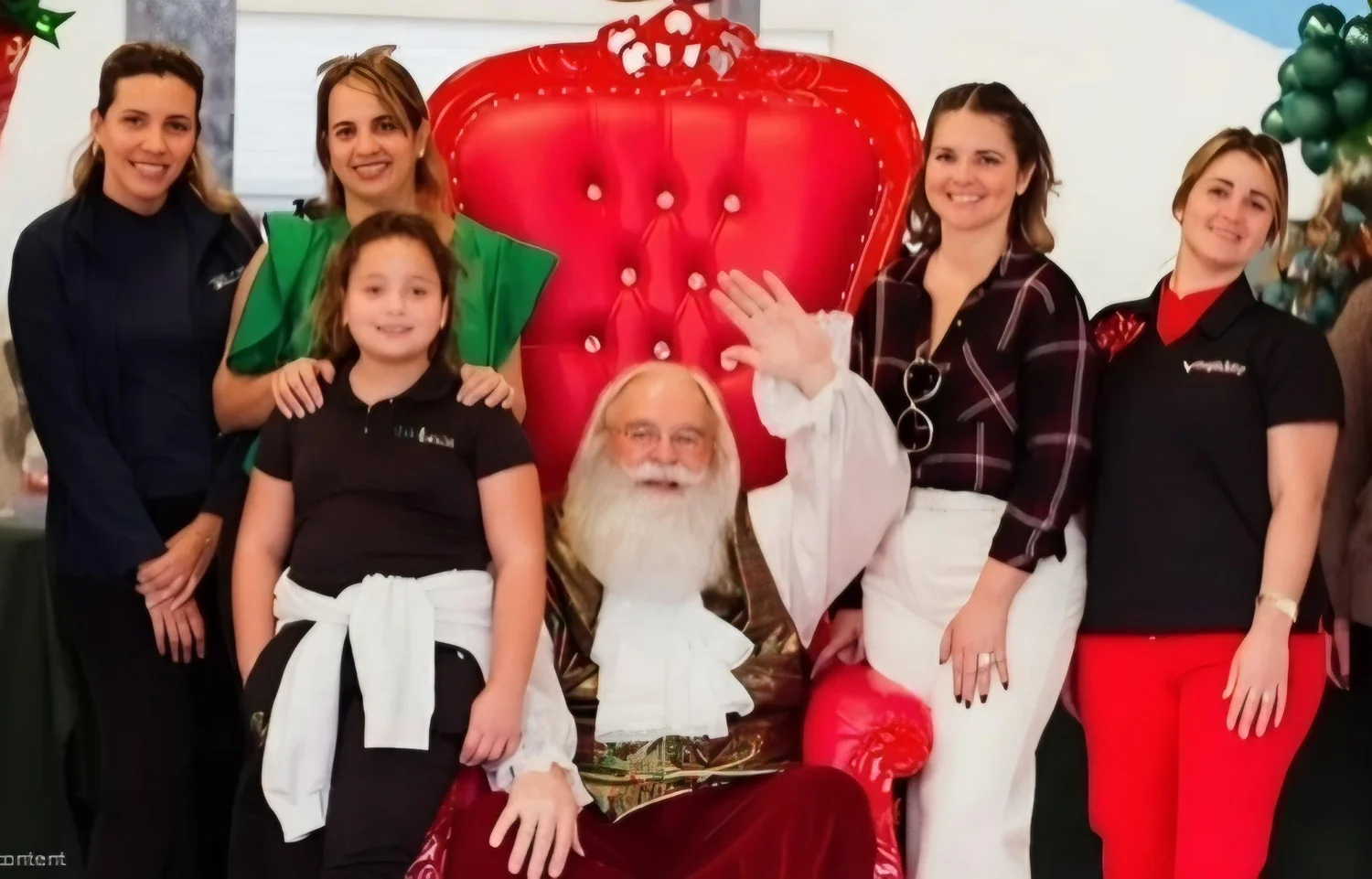 Associates and families at a Bomnin holiday event with Santa