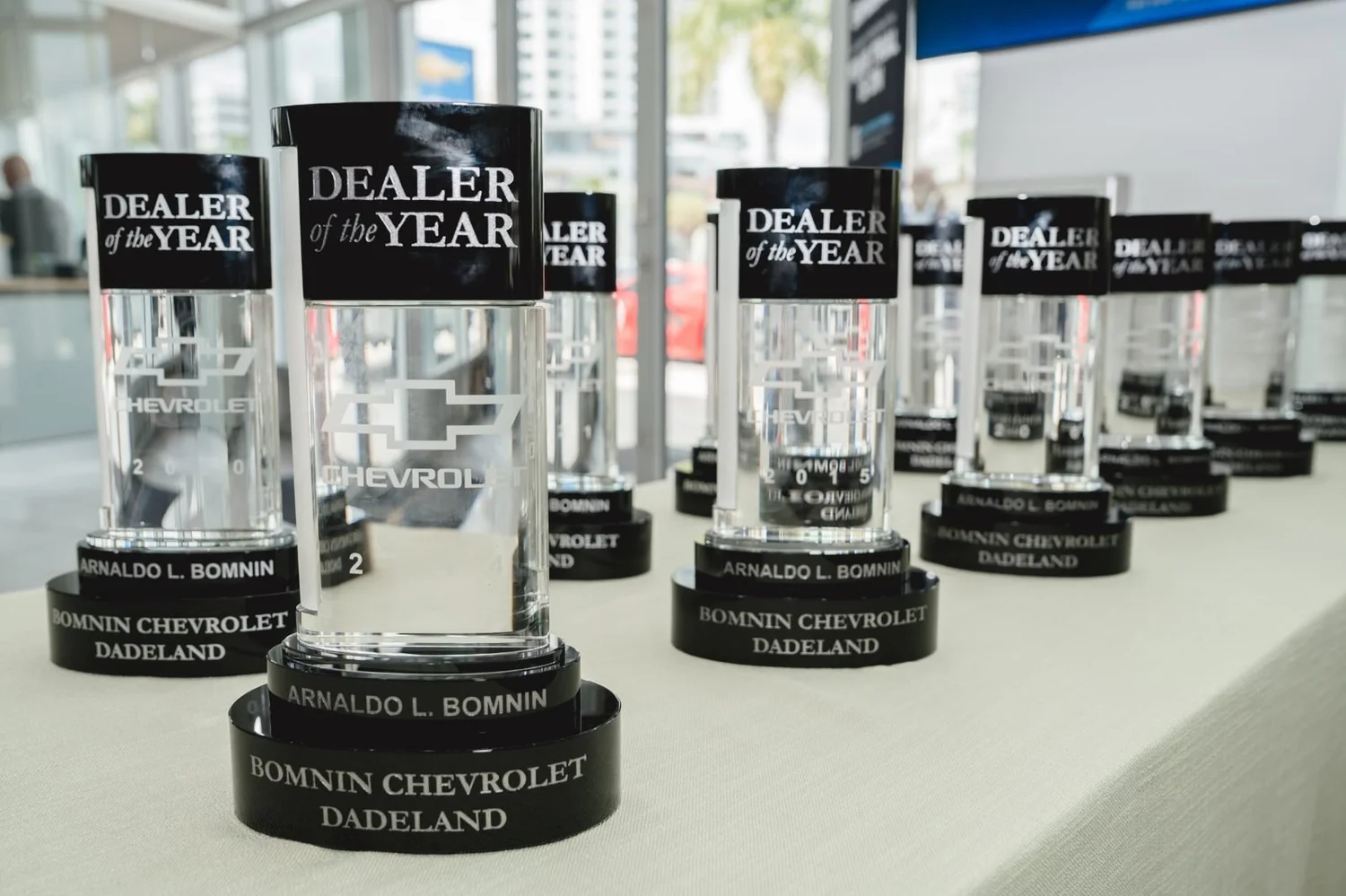 A row of Chevrolet Dealer of the Year trophies