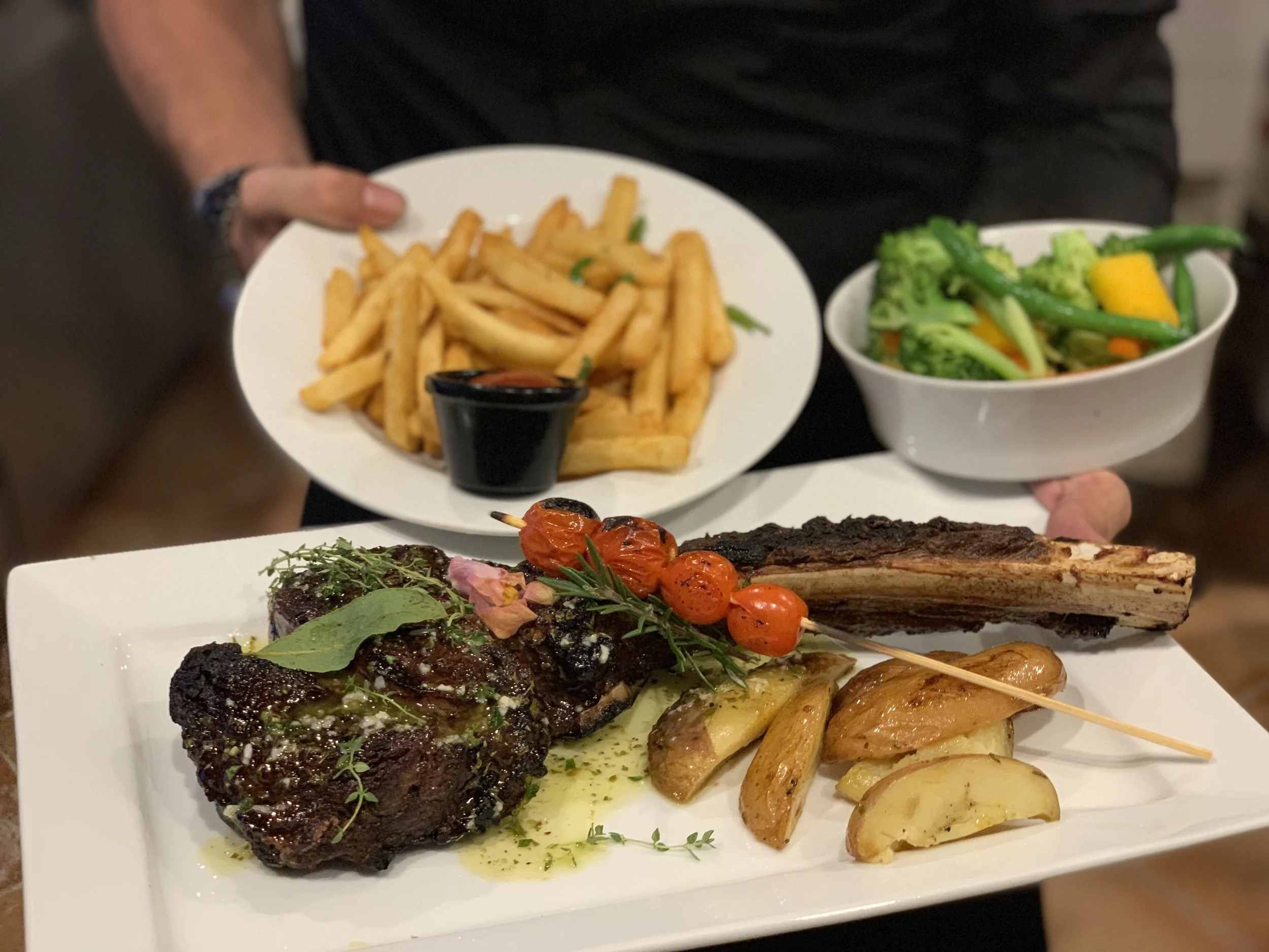 Tomahawk steak w/ chips and vegetables
