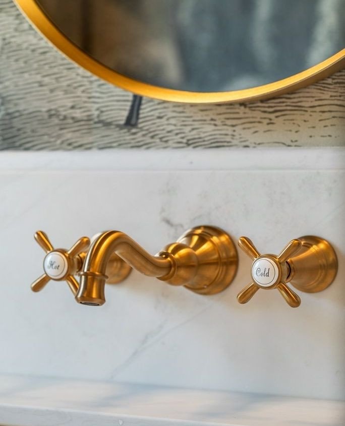It&rsquo;s the smallest details that give a room its character.⁠
⁠
In the powder room at 2 Bridlewood, vintage-inspired wall-mounted faucets in warm gold add a little old-world charm against a more refined, modern backdrop.⁠
⁠
Elegant, unexpected, an