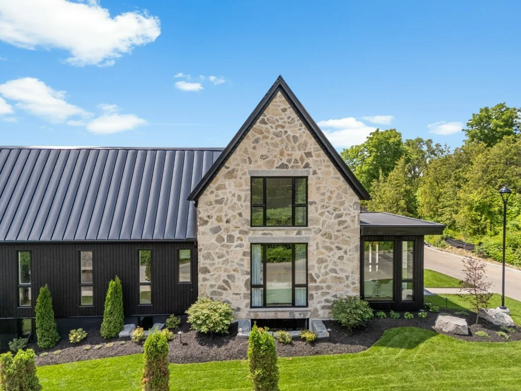 Some of the best details reveal themselves from a different angle.⁠
⁠
The side exterior of Lot 1 at Bridlewood Estates brings together the warmth and texture of charred wood siding with the timeless character of natural stone. The contrast feels both