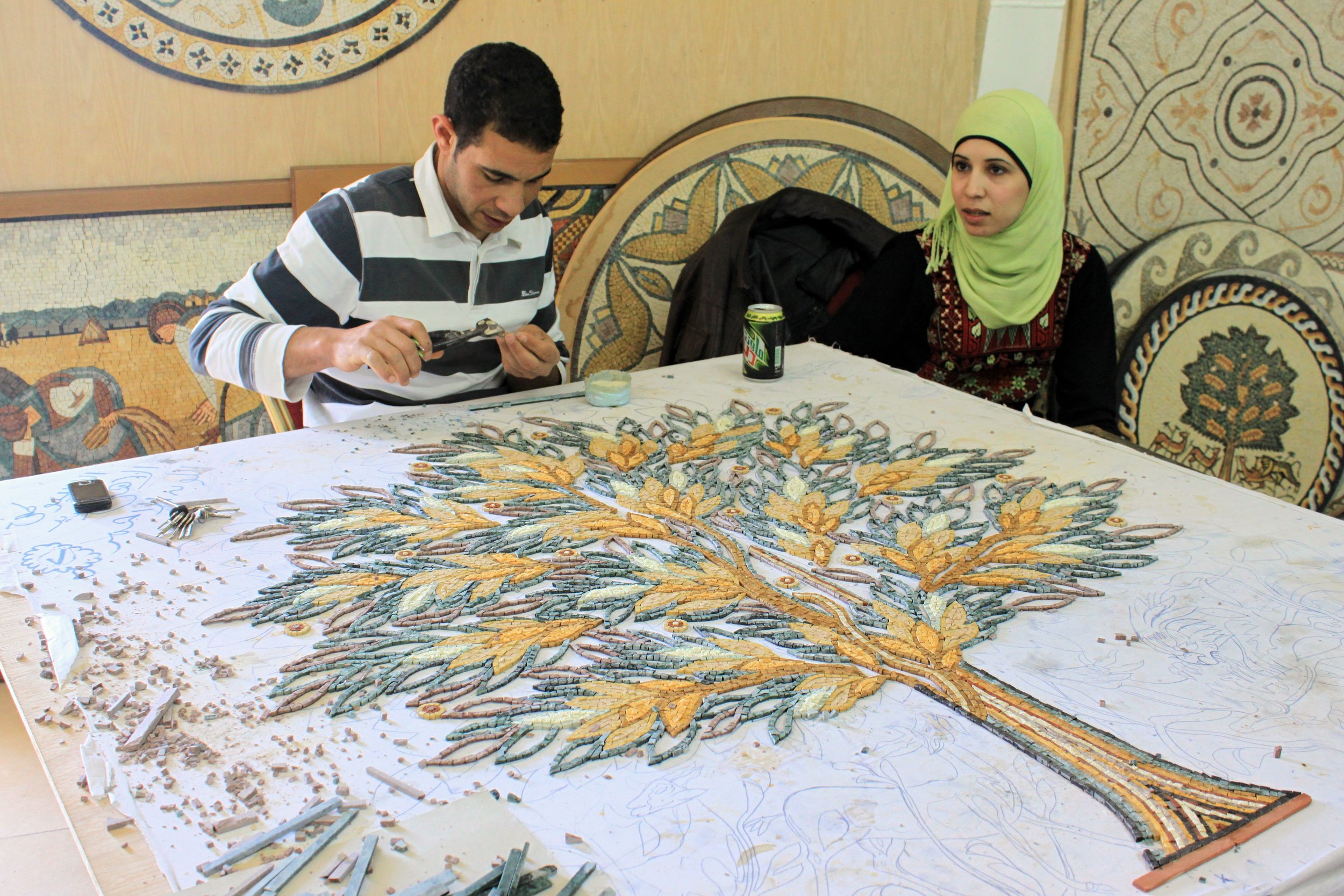 A man and woman working at a mosaic shop in Madaba, Jordan