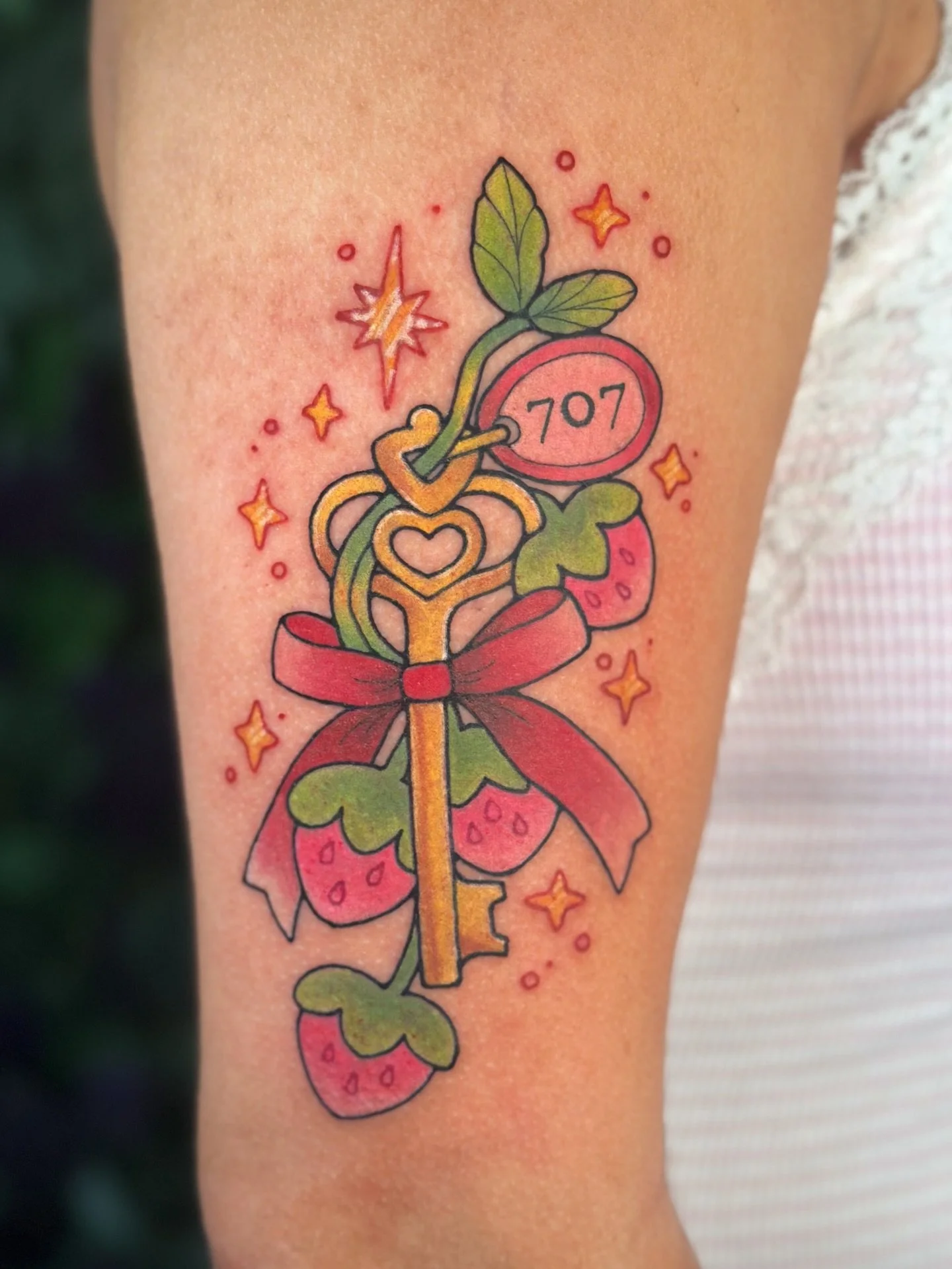 Strawberry key from my nana flash sheet 🍓 broken strawberry glass still available! 
.
See more designs available to claim @bons.lagoon booking tattoos Dec - Feb!
.
Done @slowpoke.tattoo.oc 
.
#nanatattoo #strawberrytattoo #colortattoo #animetattoo #