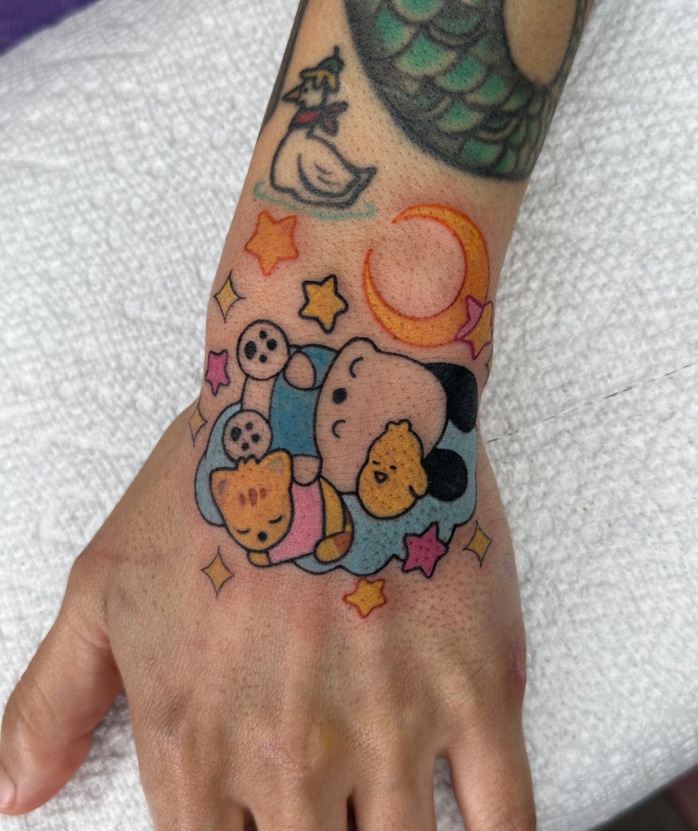 Sometimes you&rsquo;re just a sleepy girl
.
Booking tattoos for March! Form linked in bio available designs @bons.lagoon 
.
#pochacco #sanrioaesthetic #sanriocore #kawaiitattoo #handtattoo pochacco hand tattoo color tattoo