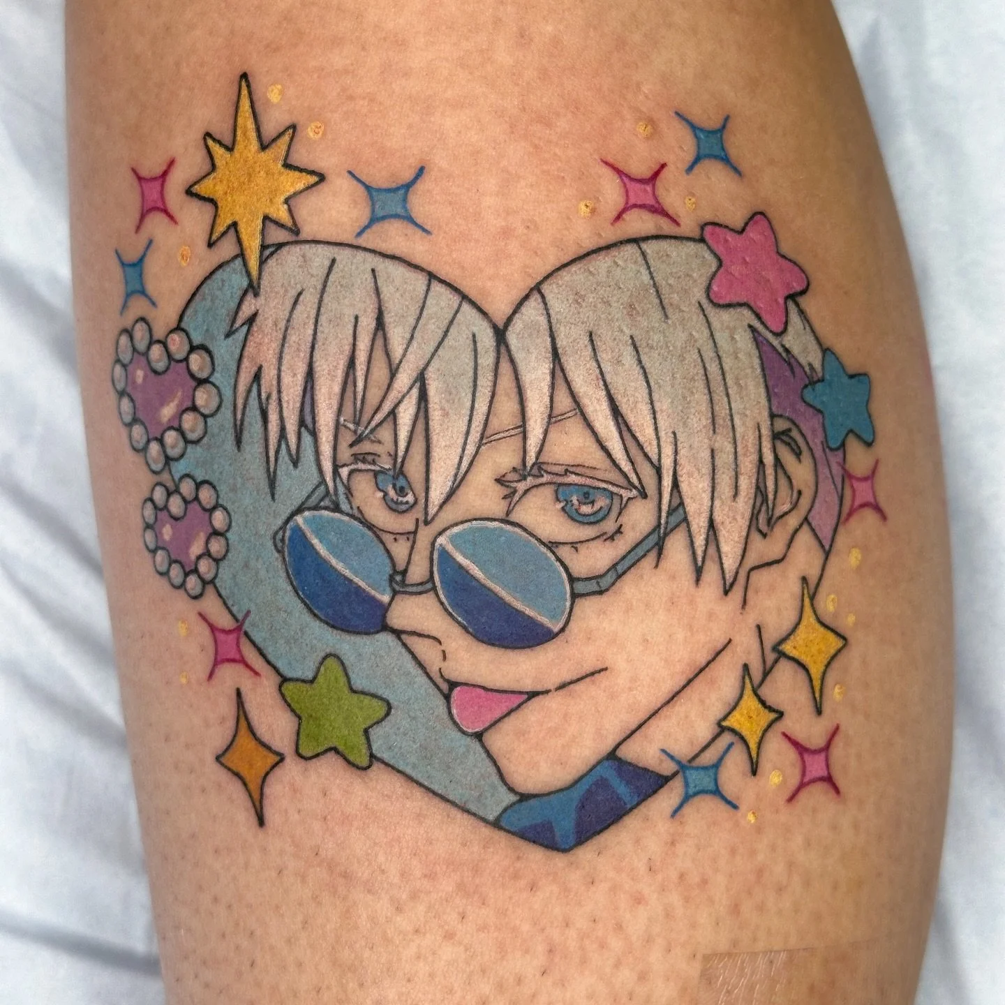 Gojo lookin cute to match sailor moon we did 2 years ago! 
.
Booking June 🩵 link in bio! Check out my flash page @bons.lagoon 
.
#animetattoos #jjk #gojousatoru gojo jjk kawaii color heart tattoo