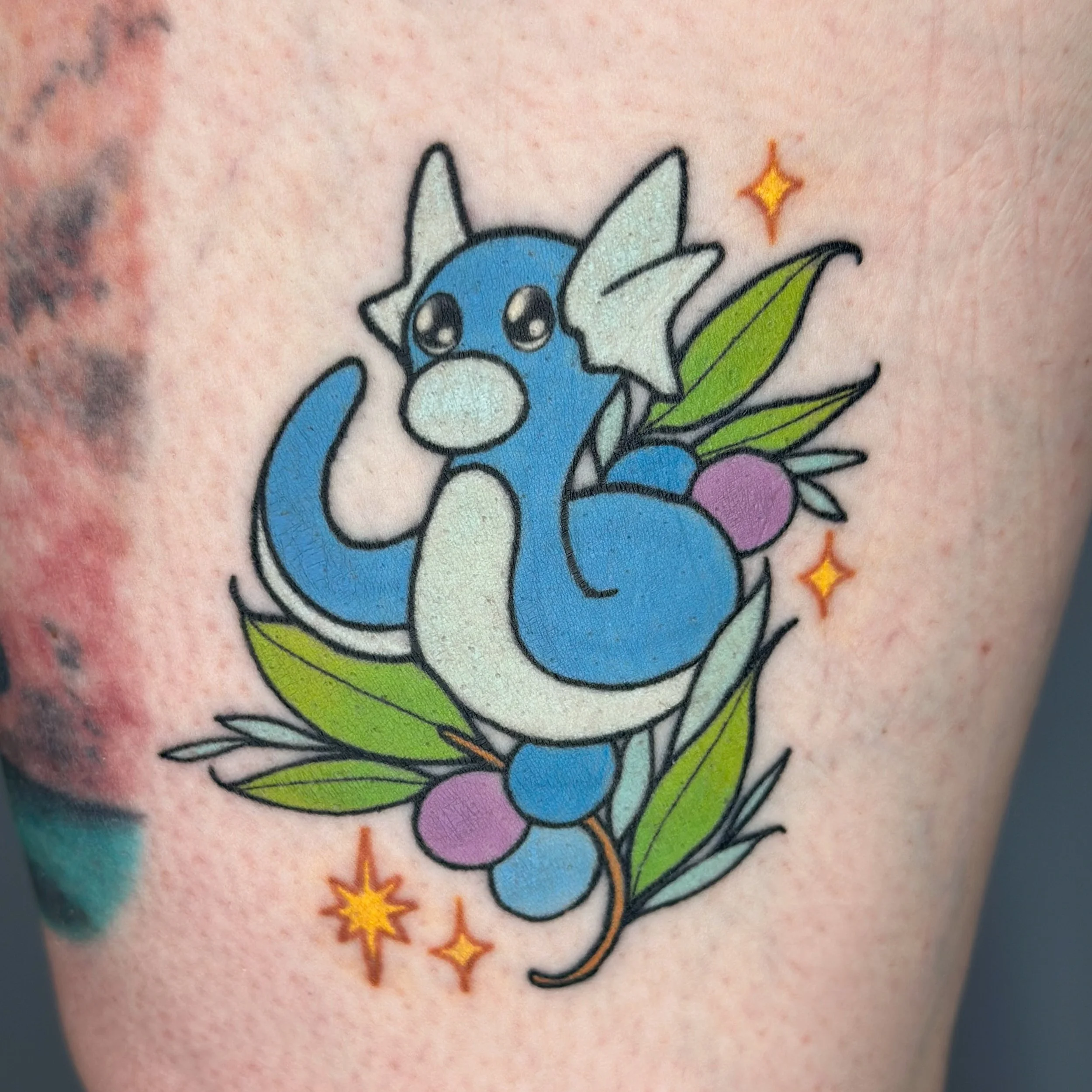 Healed and settling in! Swipe to see fresh 🤍  love getting to see stuff when it&rsquo;s not all bloody and swollen lol ! 
.
Booking tattoos for June-August! Link in bio or dm to book. See more flash @bons.lagoon 
.
#pokemontattoo #dratini #colortatt