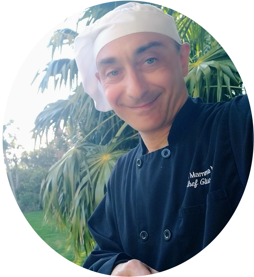 Executive Chef Giuseppe Urbano, personal chef in Sarasota, smiling outdoors in his chef uniform.